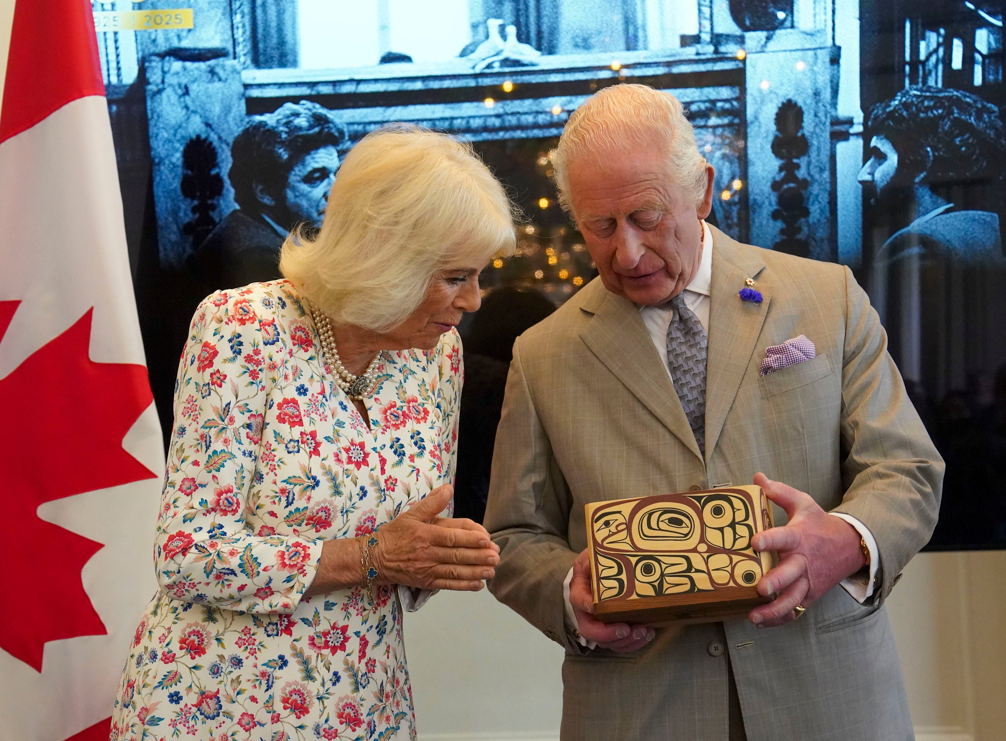 Britain's King Charles and Queen Camilla look at the Key to Canada House which was presented to the King by High Commissioner for Canada, Ralph Goodale, during a visit to Canada House to mark 100 years since it opened, in London, Tuesday, May 20, 2025