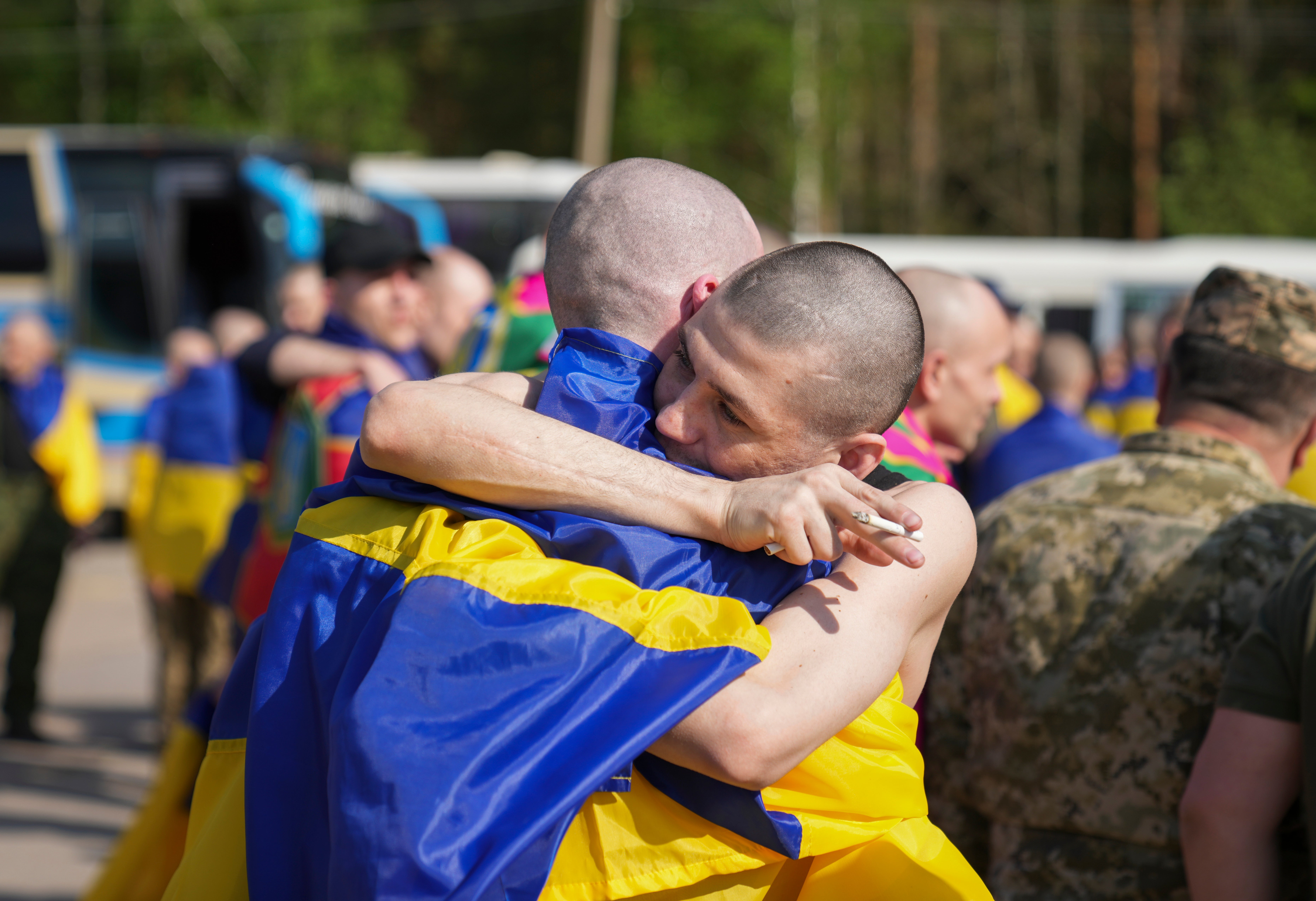 Two POWs embrace after being reunited following a major prisioner exchange between Ukraine and Russia