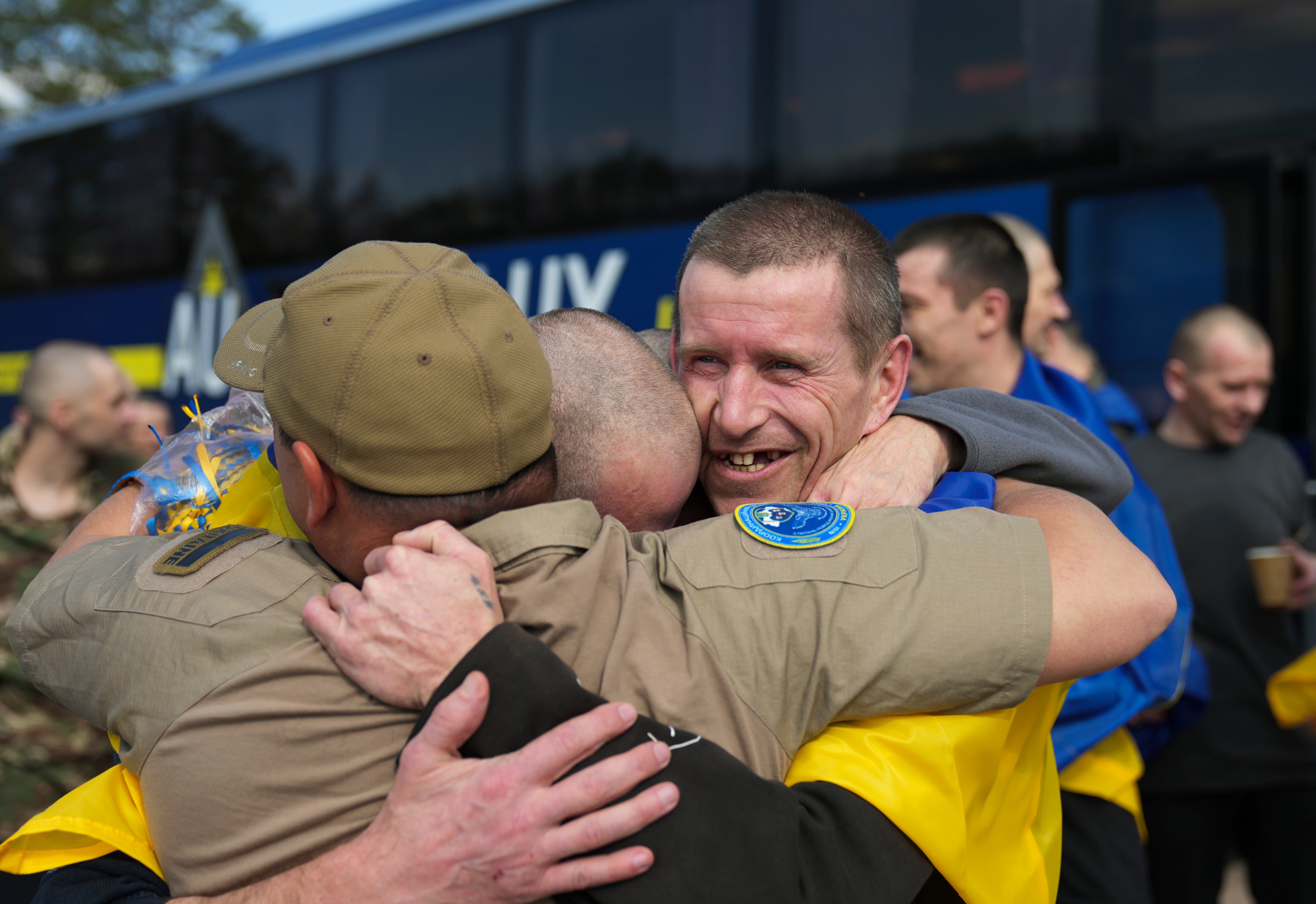 Prisoners of war embrace after returning to Ukraine