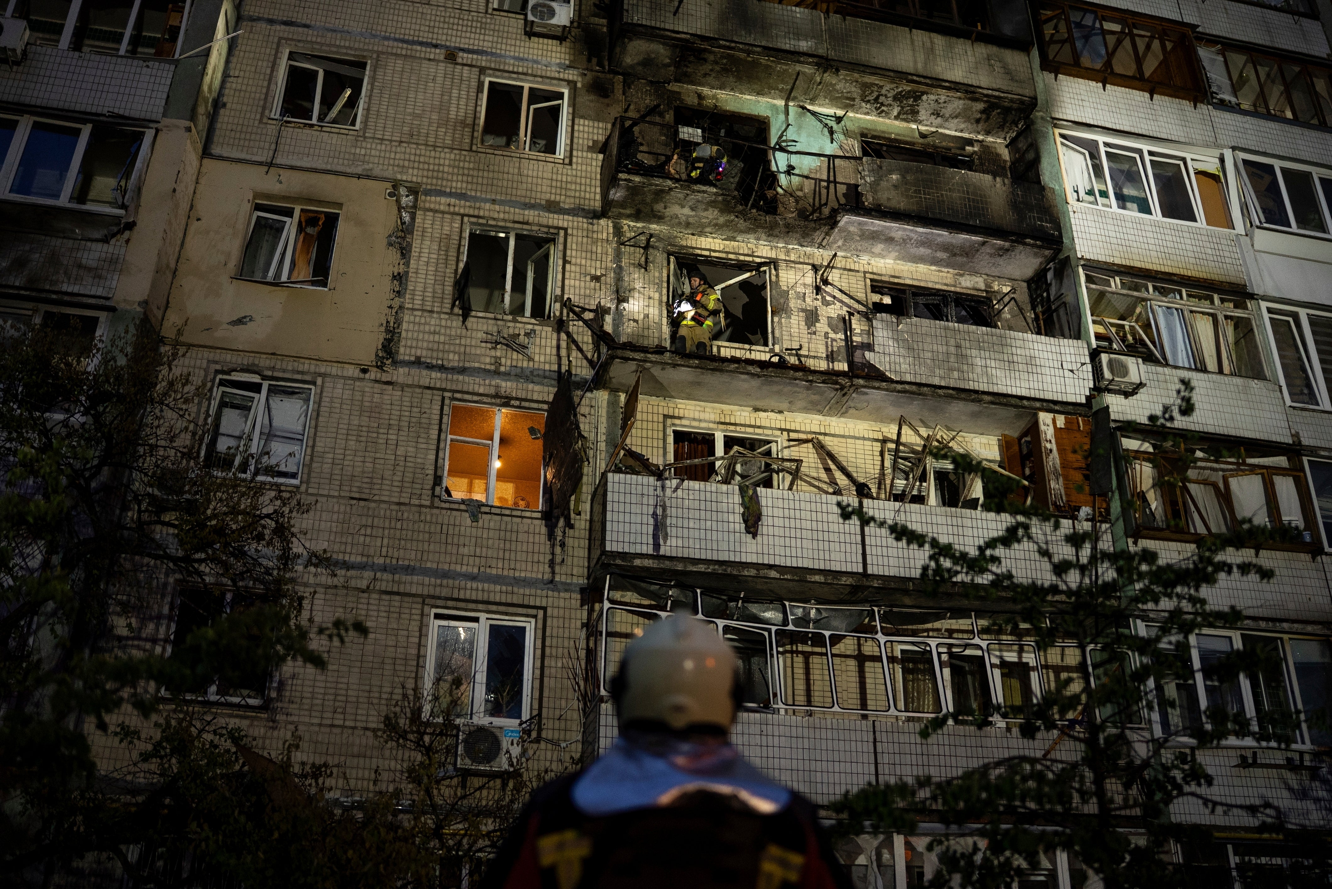 Emergency workers at a damaged building following a Russian strike in Kyiv, Ukraine