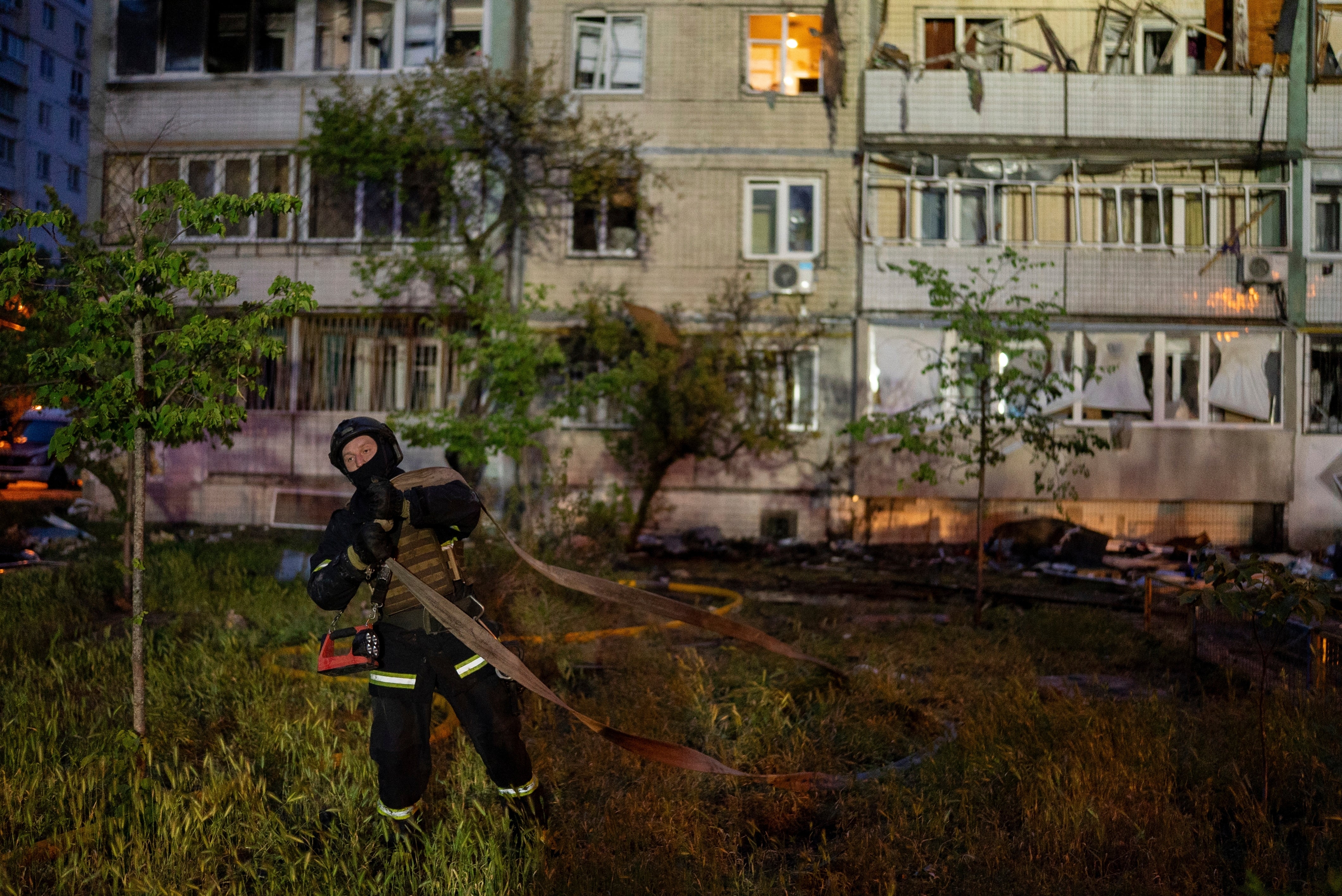 A firefighter works on the site of a residential building damaged after a Russian attack in Kyiv, Ukraine, Saturday, May 24, 2025. (AP Photo/Alex Babenko)