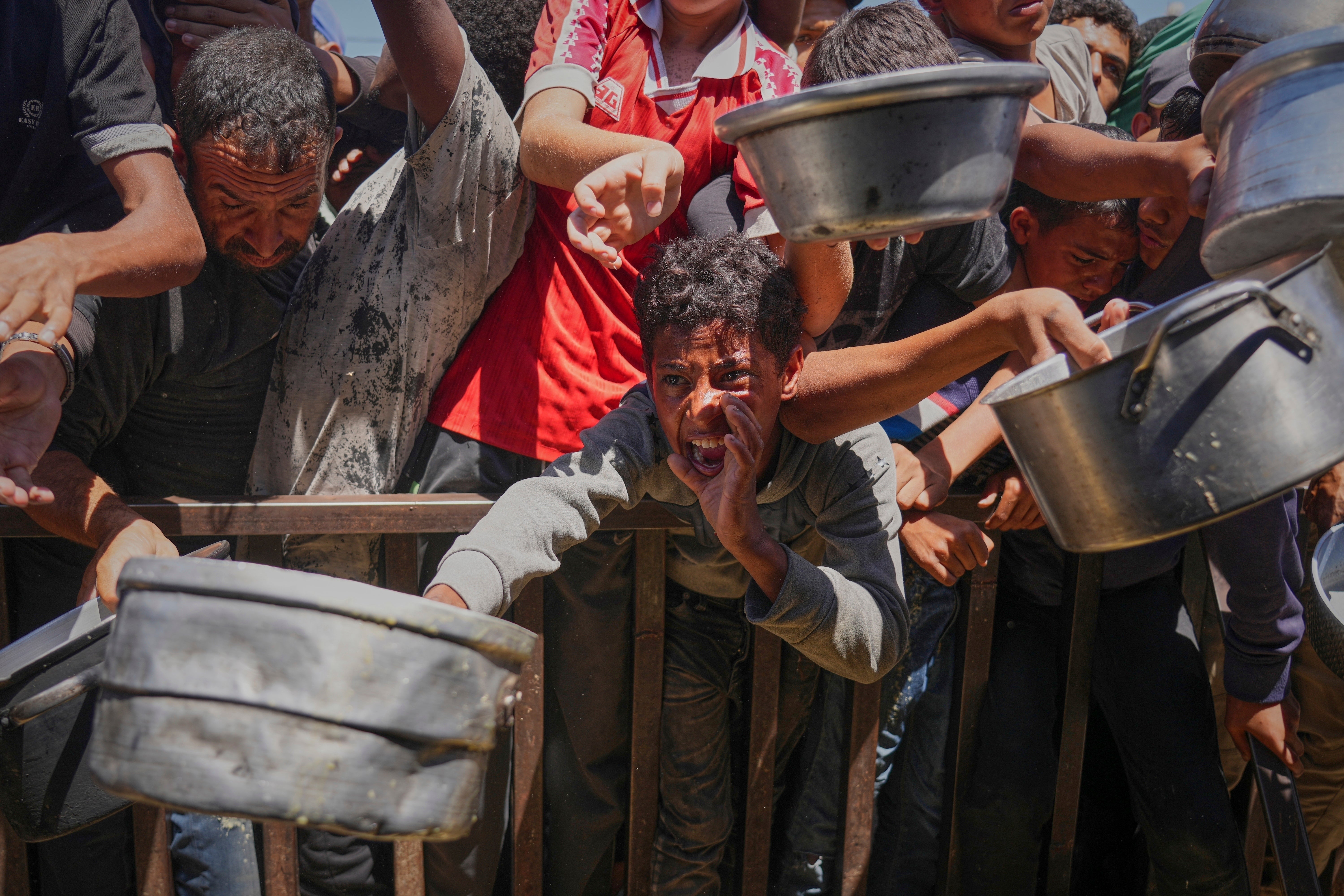 Palestinians line up for an aid distribution site in Khan Younis