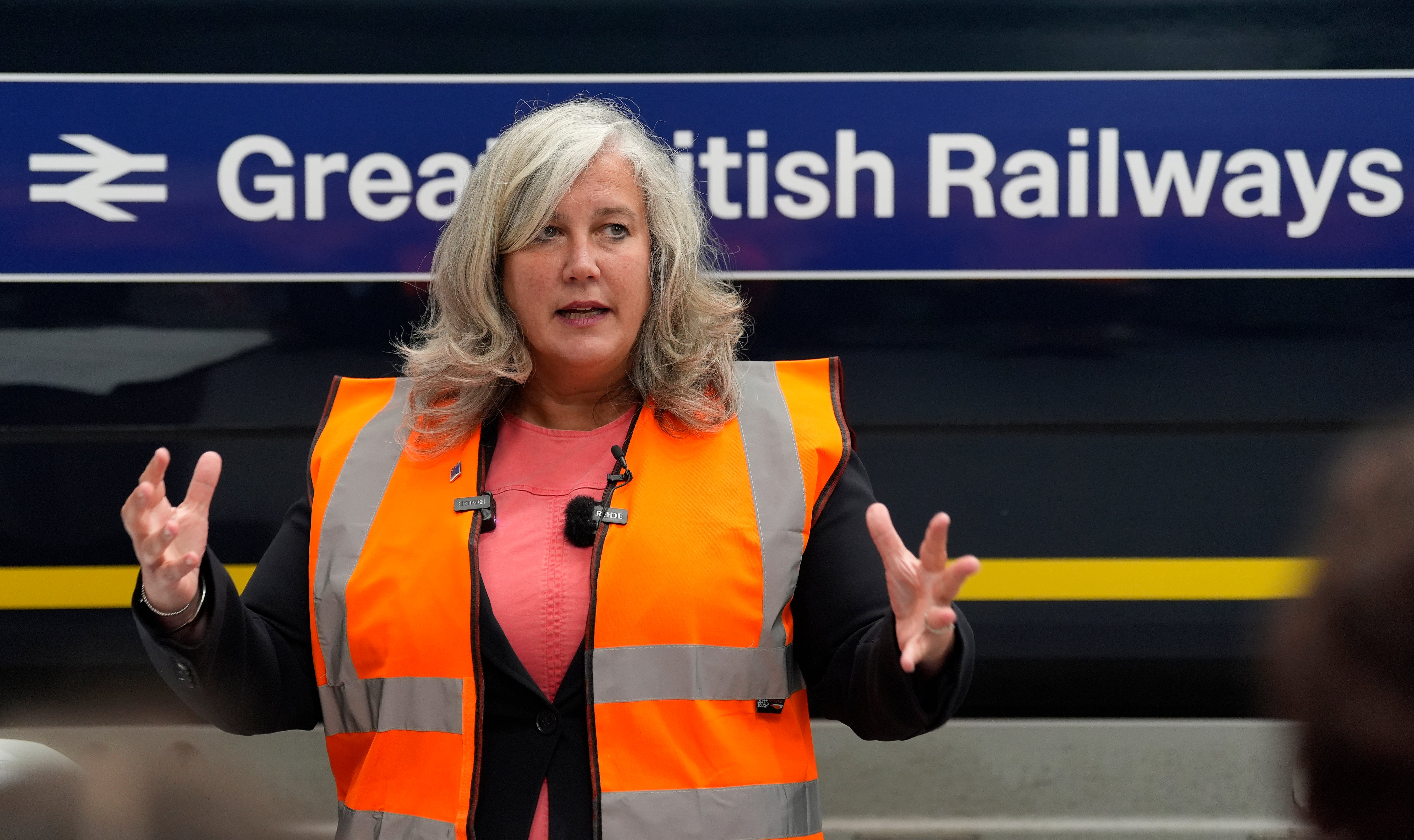 Transport Secretary Heidi Alexander giving a speech in front of a train