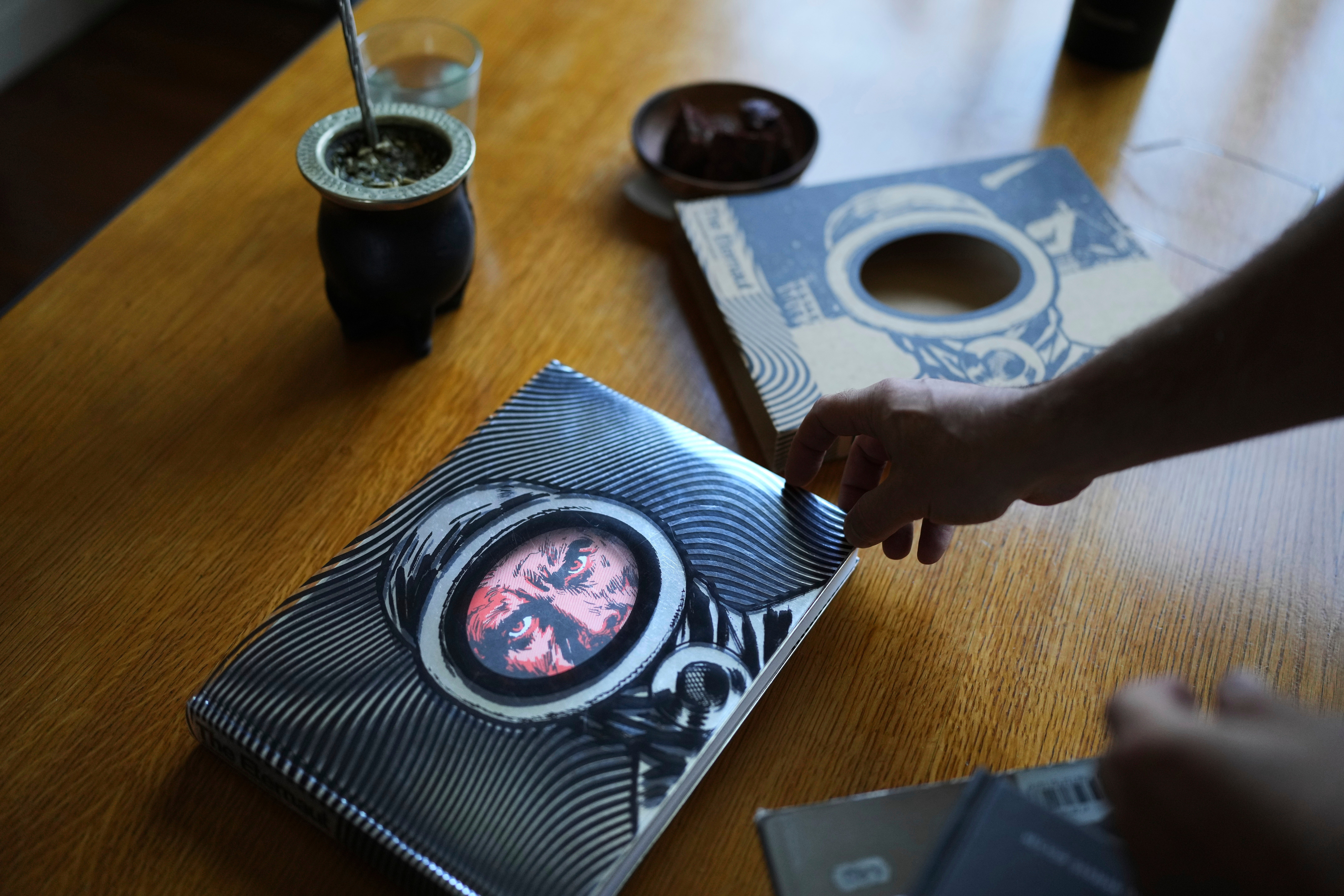 Martin Oesterheld holds an English version of sci-fi comic,