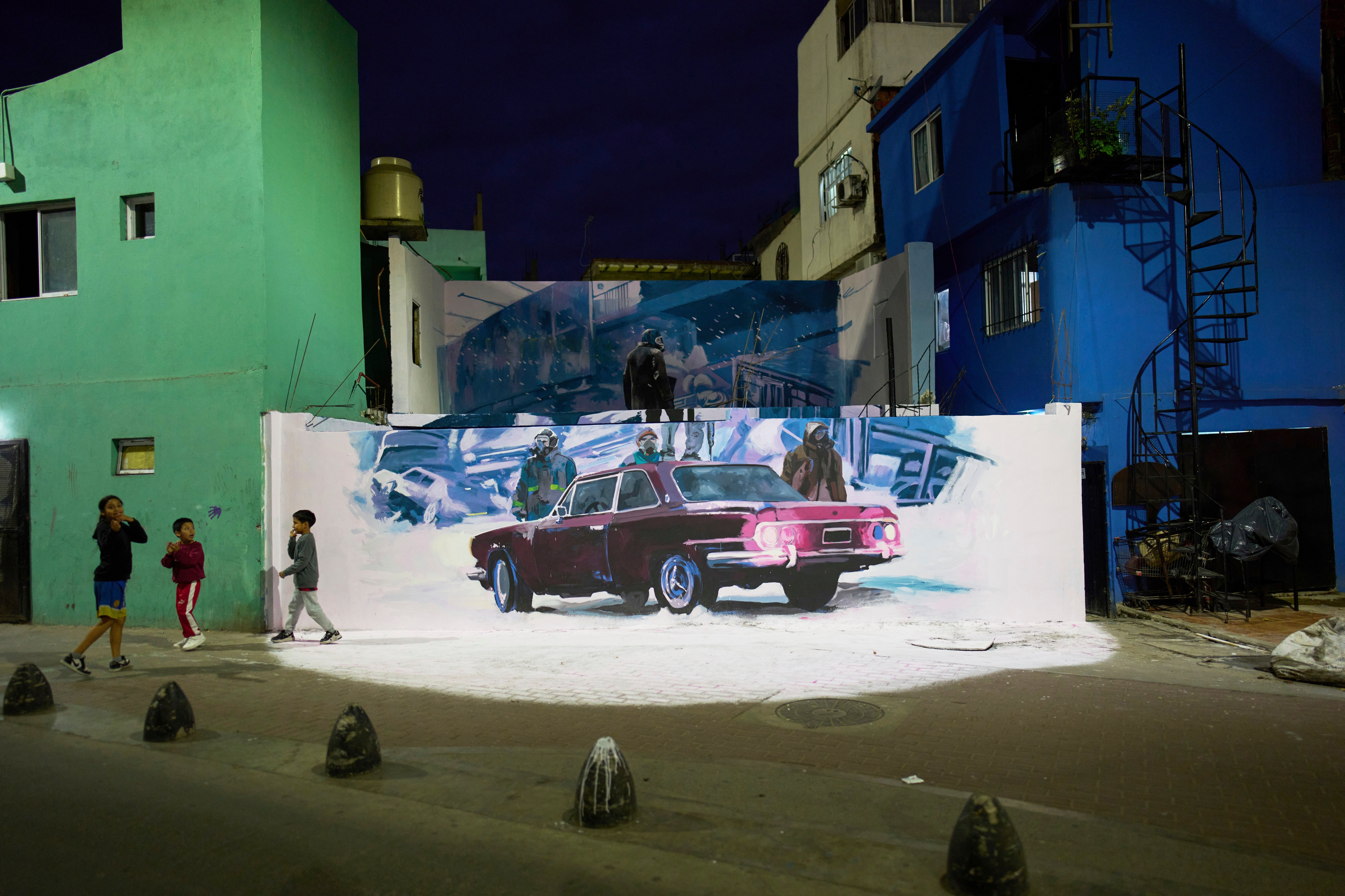 Children hang out next to a promotional mural for the Netflix series