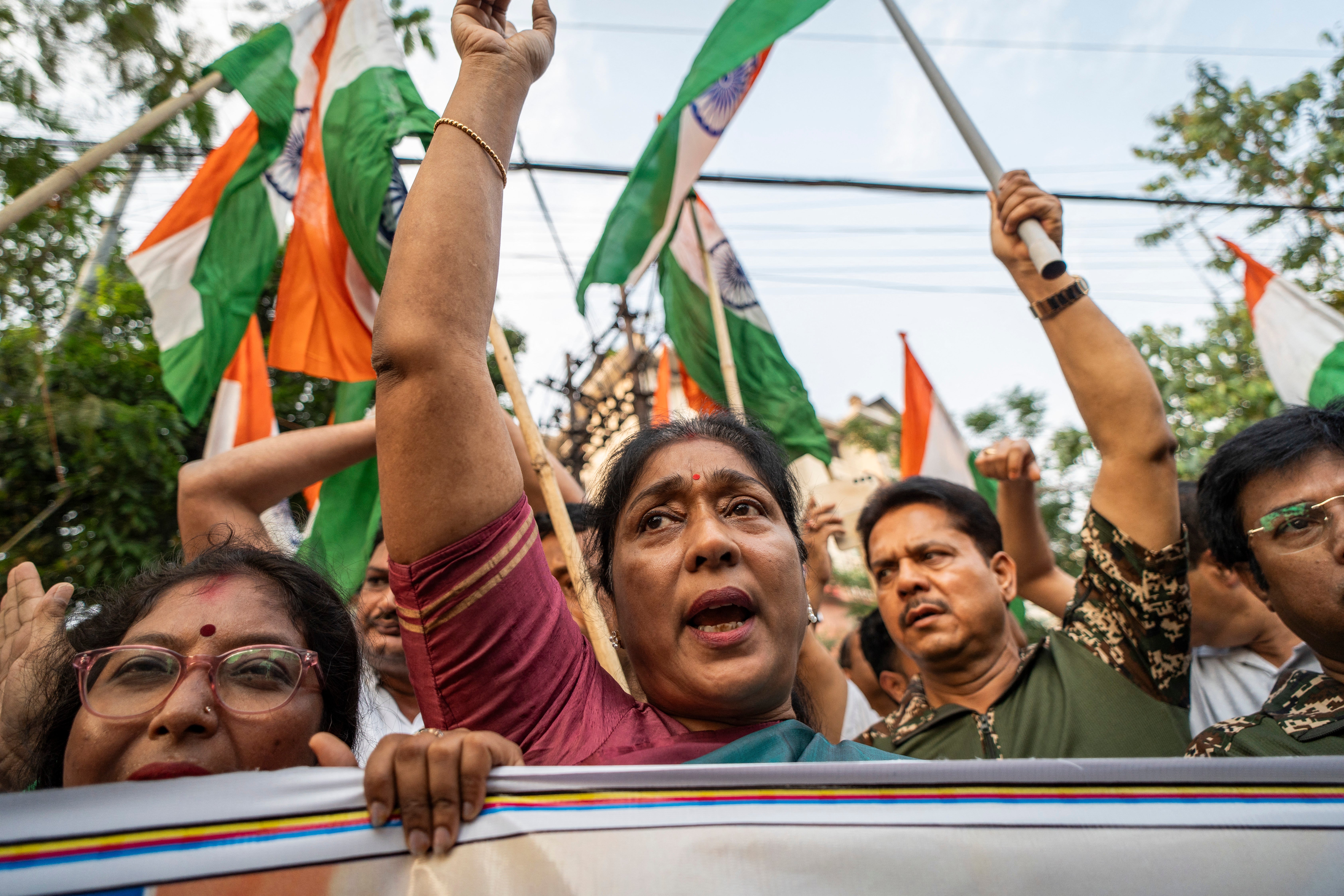 Supporters of the Congress party wave Indian flags to celebrate military strikes on Pakistan