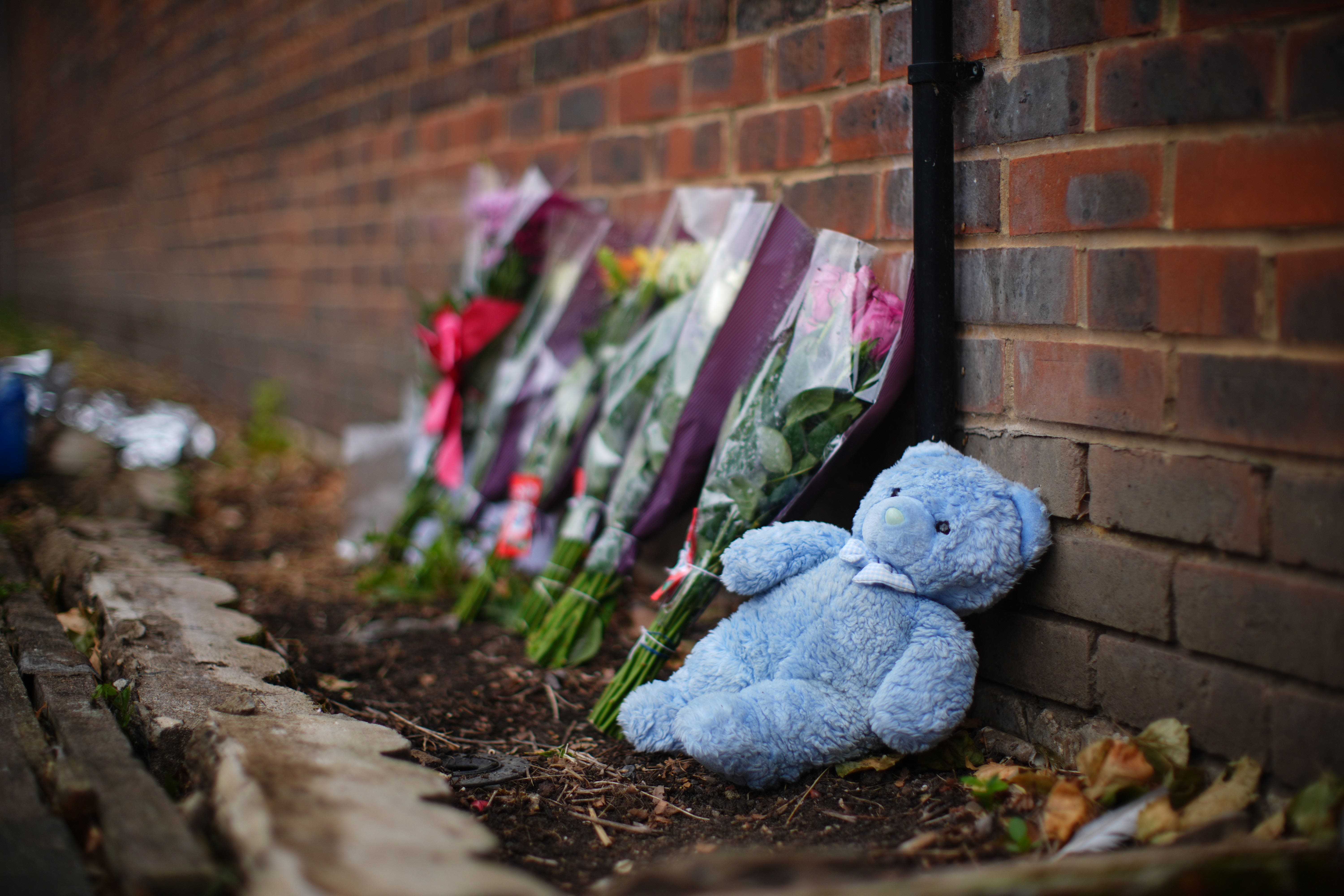 Floral tributes were left near the scene where the mother and three of her children died after a house fire (James Manning/PA)