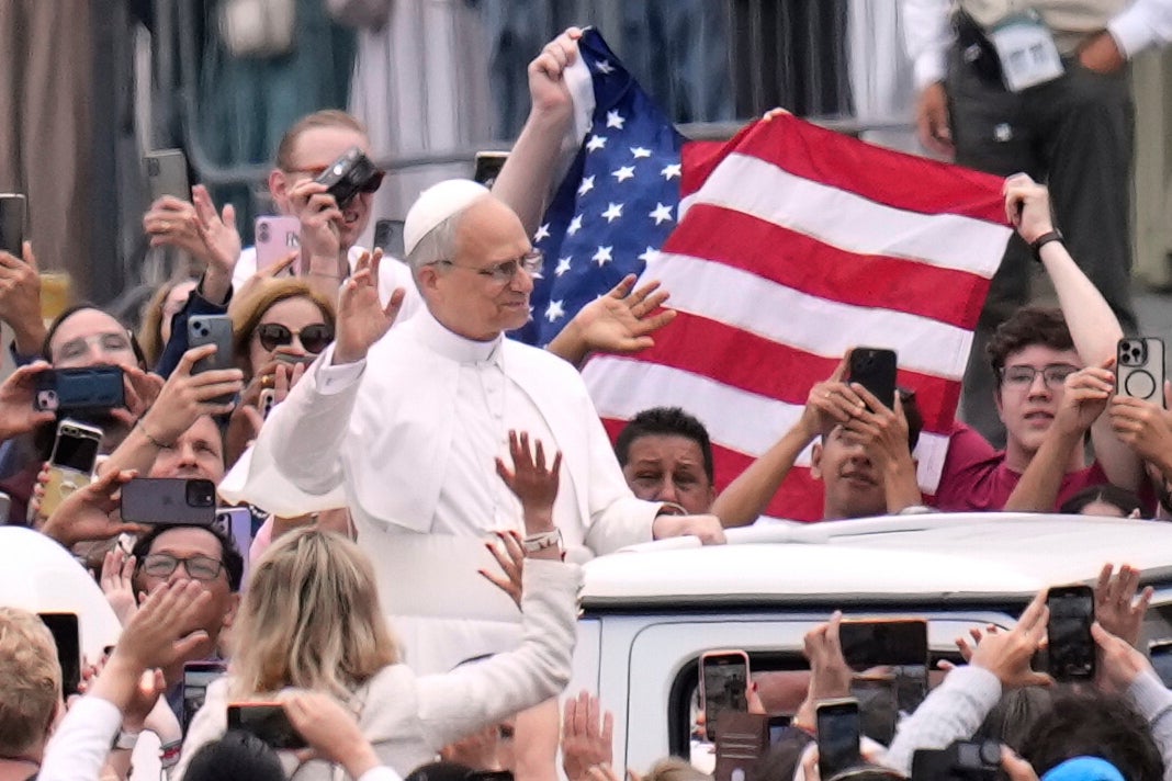 Pope Leo XIV waves as he arrives for his first weekly general audience in St. Peter's Square at The Vatican, Wednesday, May 21, 2025. (AP Photo/Gregorio Borgia)