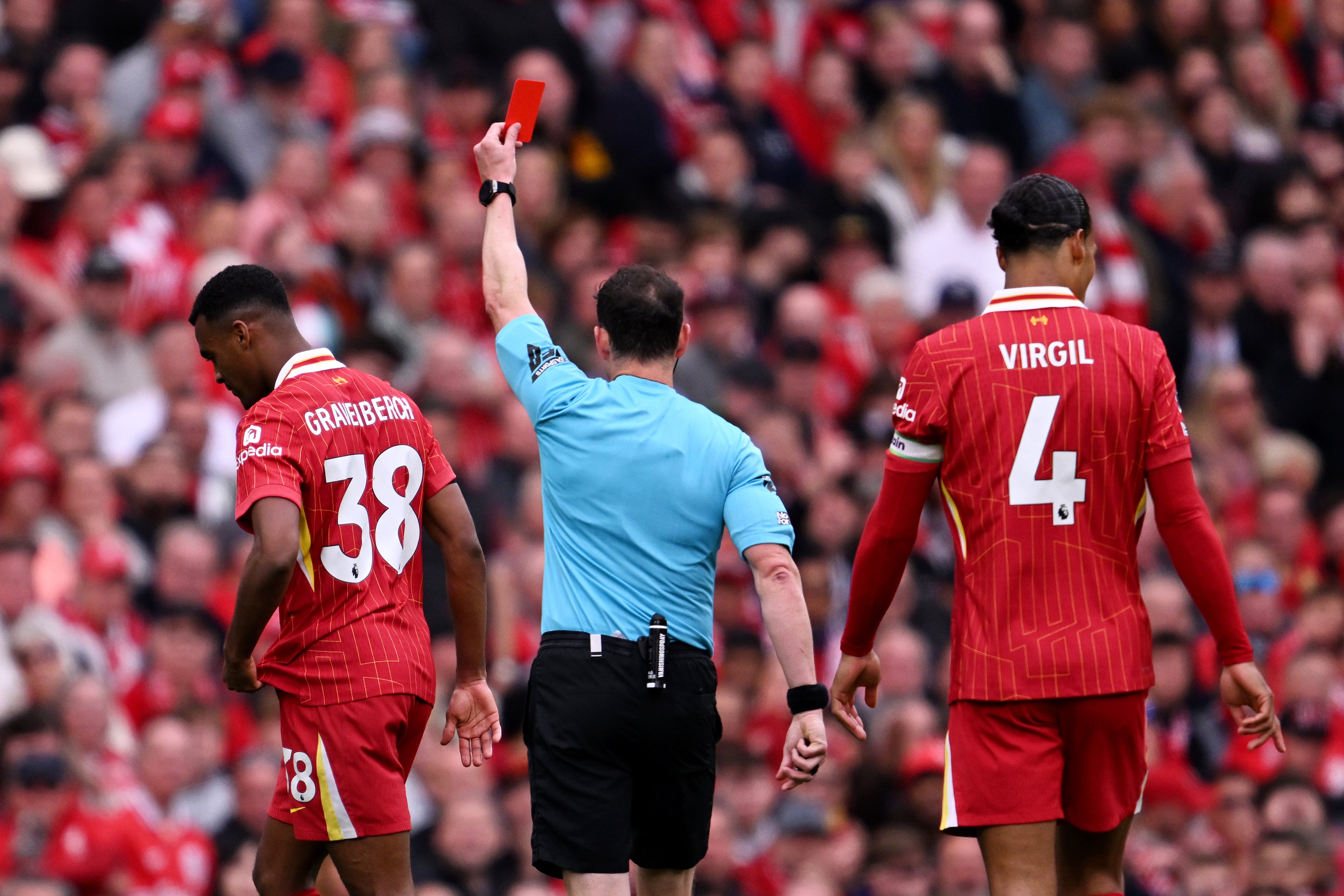 Referee Darren England gives a red card to Liverpool's Dutch midfielder Ryan Gravenberch