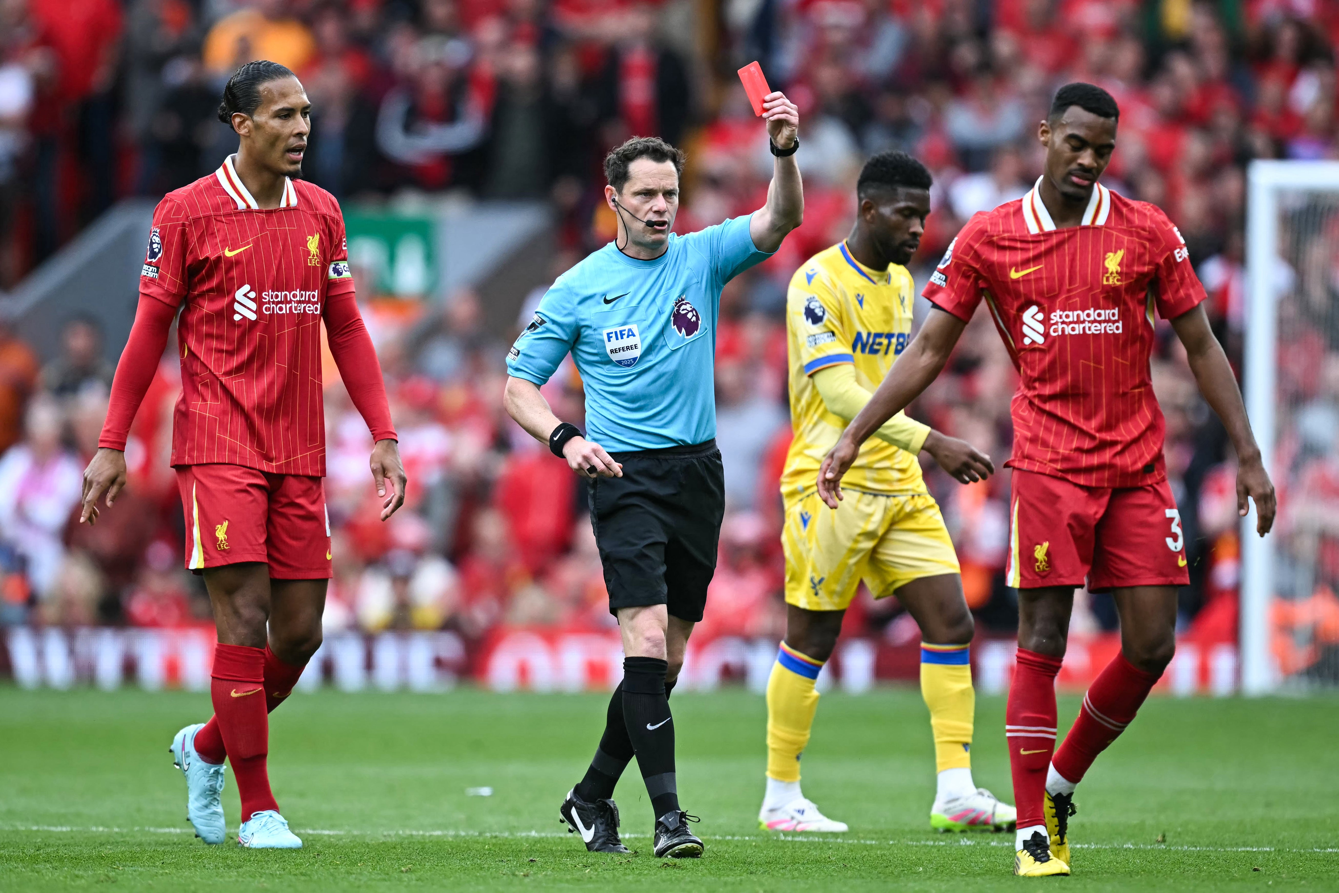 Referee Darren England gives a red card to Liverpool's Dutch midfielder Ryan Gravenberch