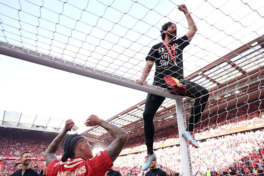 Alisson Becker of Liverpool celebrates on top of the goal, as Liverpool are crowned the Champions of the Premier League for the 2024/25 Season