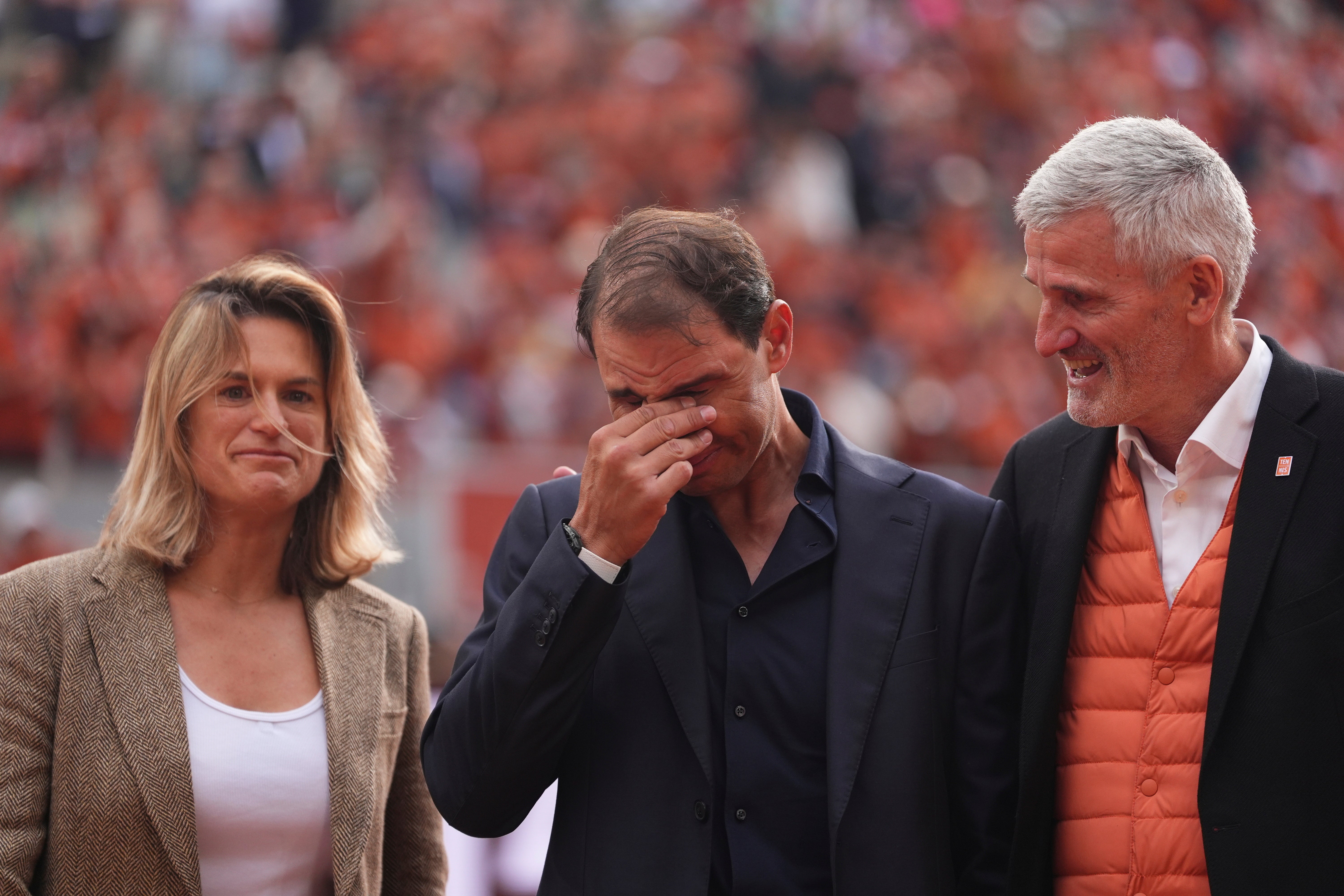 Rafa Nadal, center, stands between French tennis federation President Gilles Moretton, right, and is Roland-Garros tournament director Amelie Mauresmo