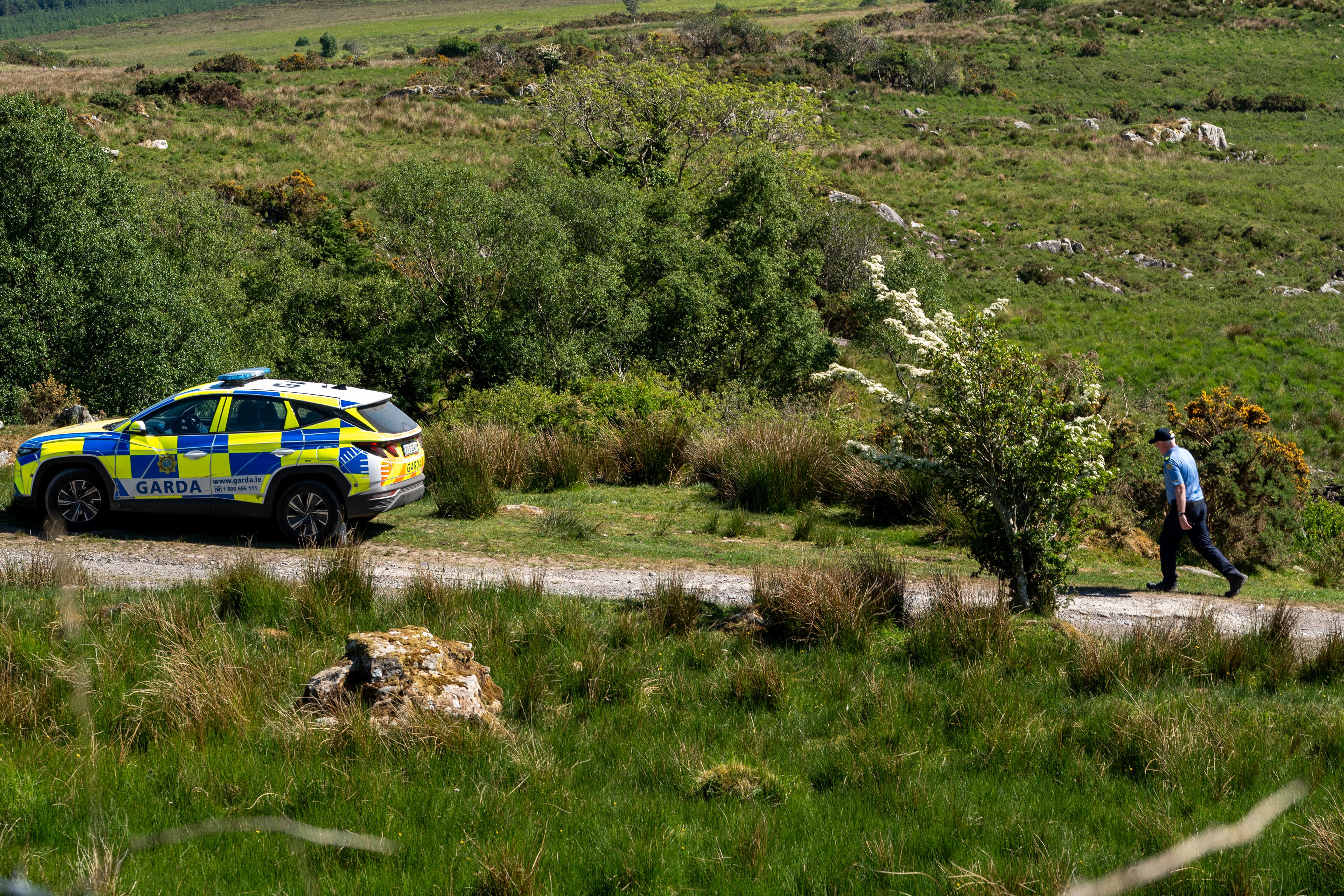 Gardai at the scene in Carrig East, Kenmare, investigating the disappearance of Co Kerry farmer Michael Gaine (Noel Sweeney/PA)