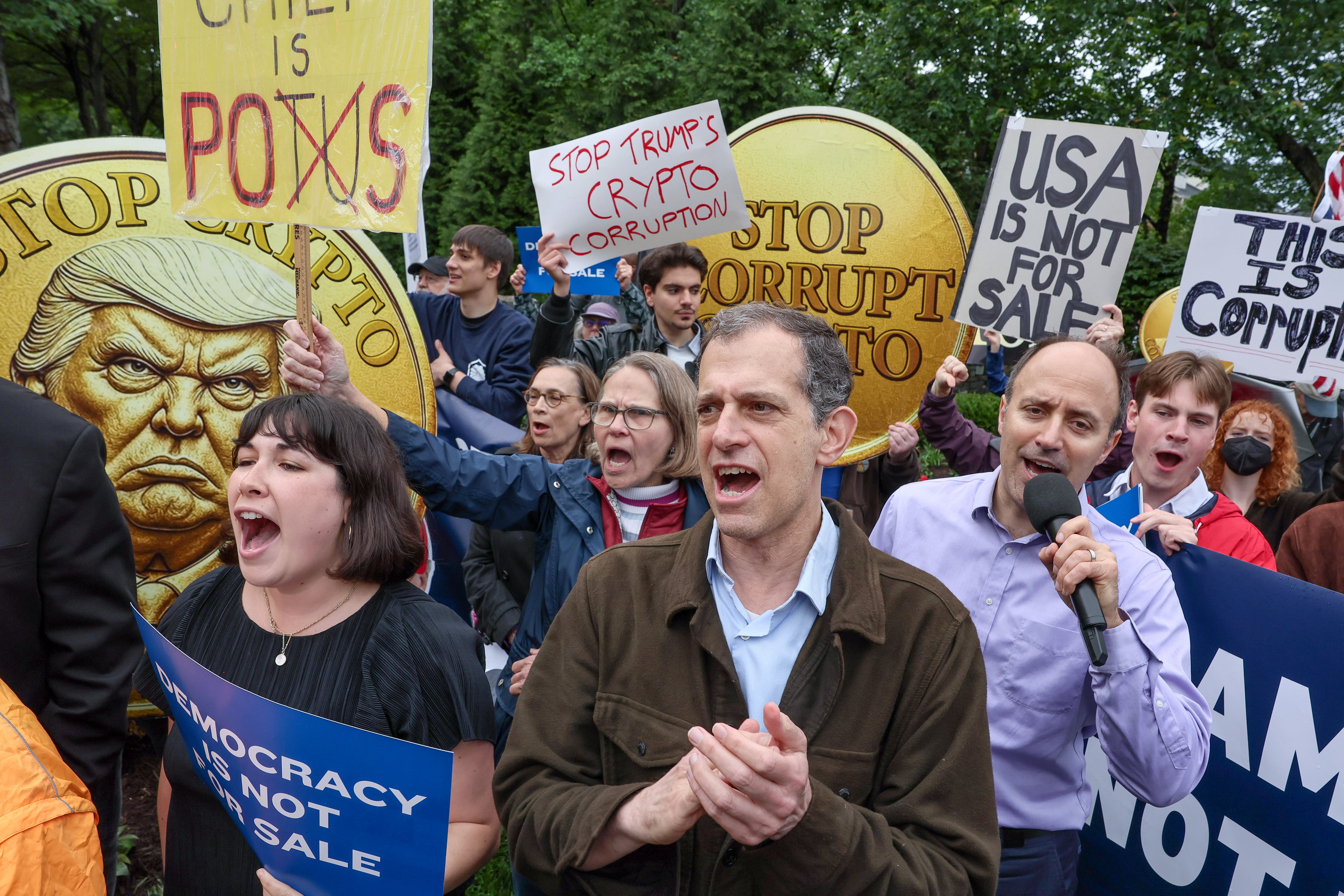 Co-president of Public Citizen Robert Weissman and Americans for Financial Reform Cryptocurrency and Financial Technology Associate Director Mark Hays lead chants during the "America is Not for Sale" Rally Against Trump's Crypto Dealings at the Trump National Golf Club on May 22, 2025 in Washington, DC.