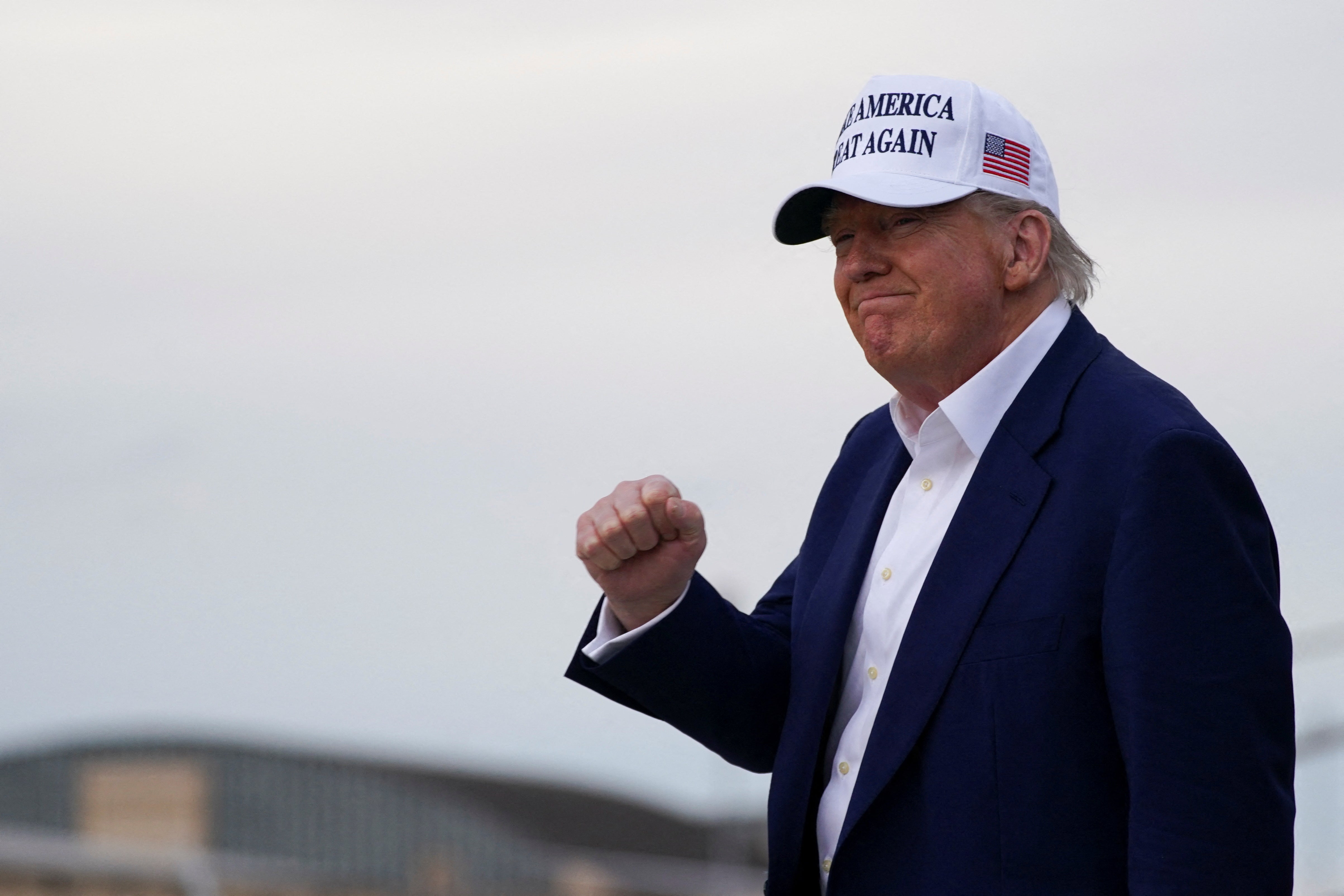 US president Donald Trump raises his fist as he arrives at Joint Base Andrews in Maryland