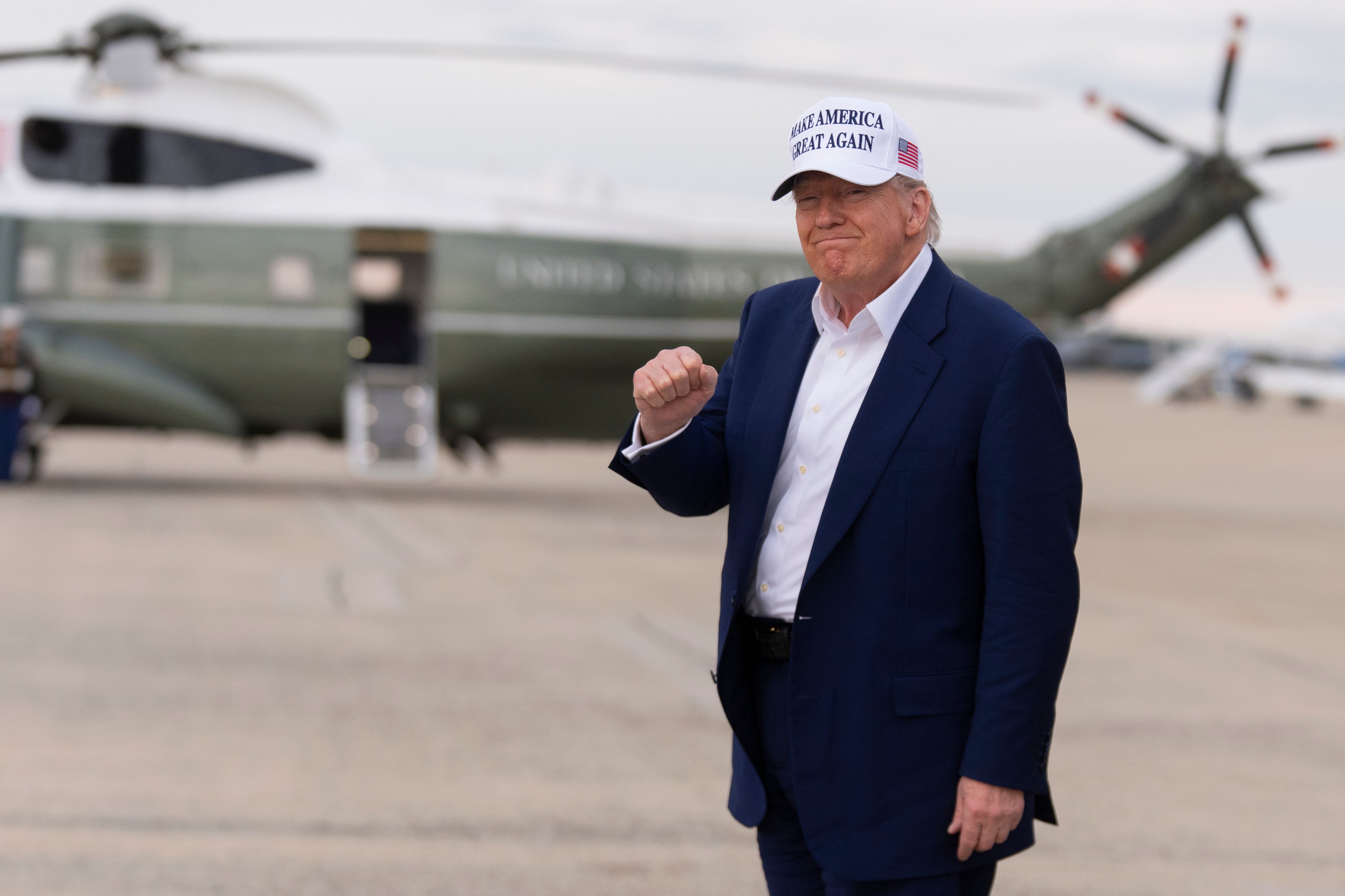 Donald Trump gestures as he arrives at Joint Base Andrews on Air Force One