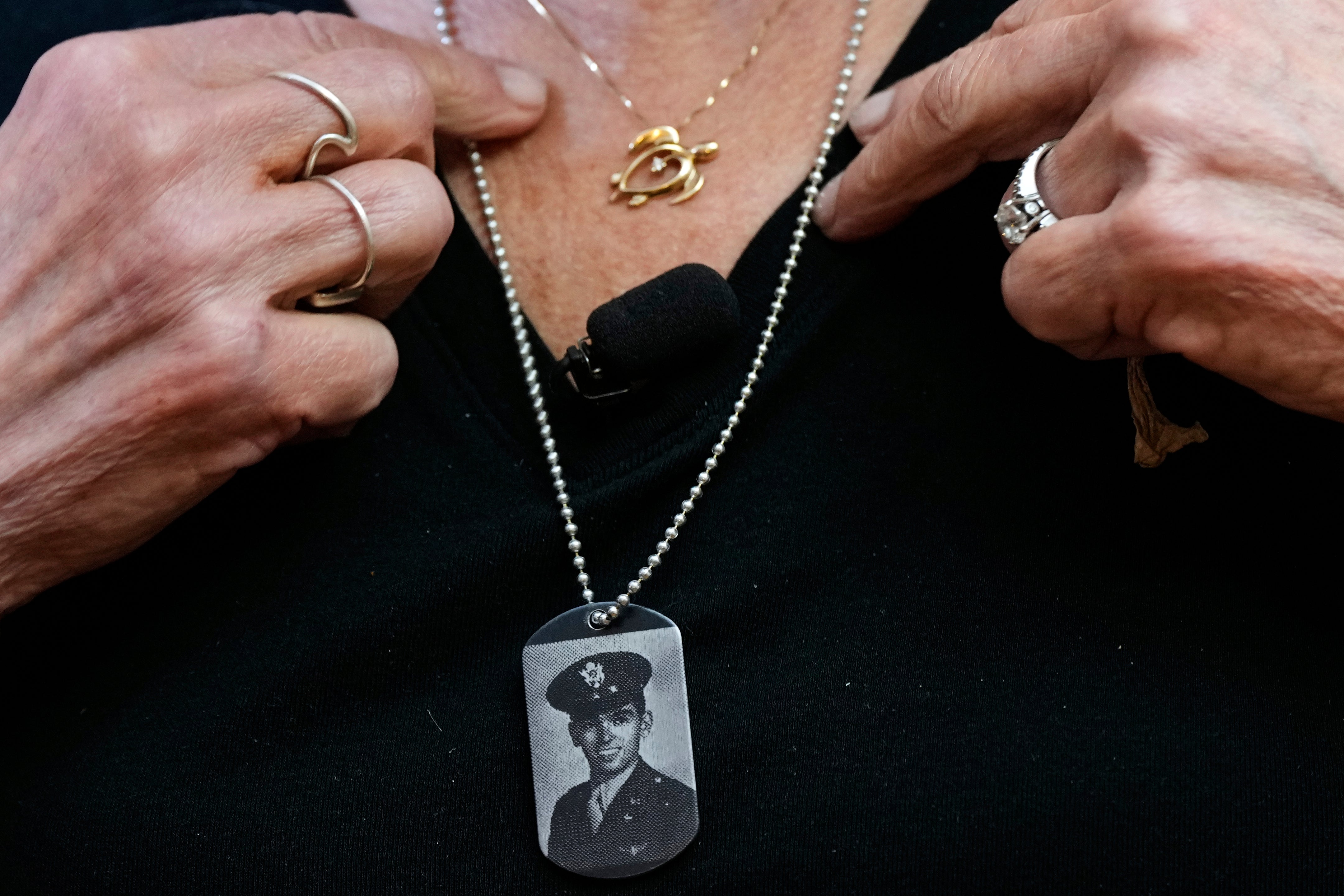 Diane Christie wears a necklace with a photograph of her uncle, World War II U.S. Army Air Forces 2nd Lt. Thomas Kelly