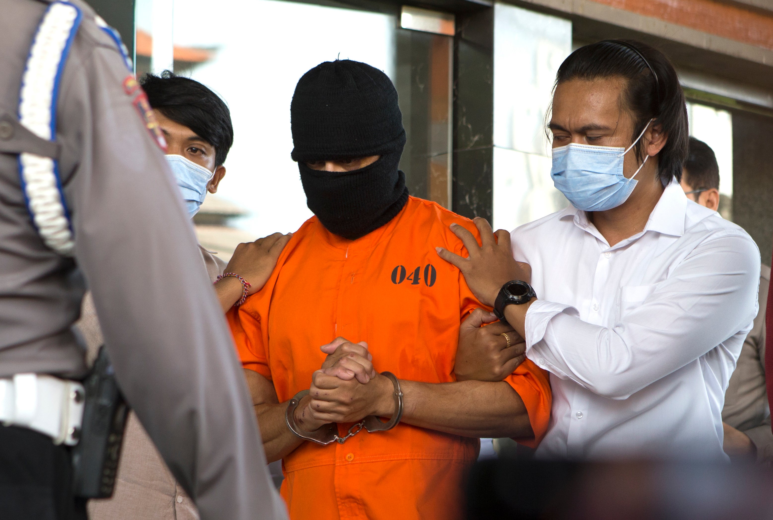An Australian man arrested for allegedly smuggling cocaine is escorted to a news conference at the police headquarters in Bali, Indonesia, Monday, May 26, 2025. (AP Photo/Firdia Lisnawati)