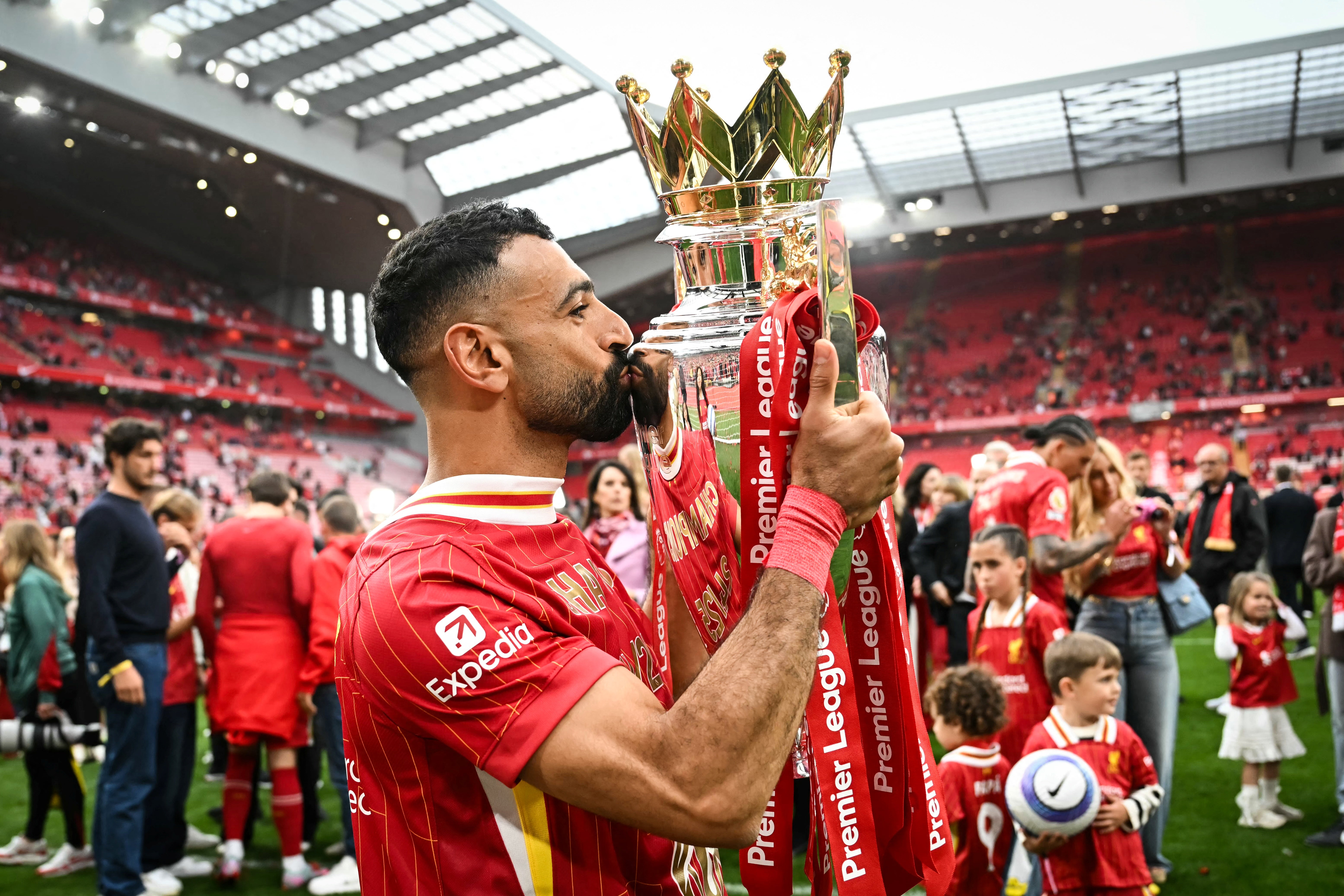 Mohamed Salah celebrates as he kisses the Premier League trophy