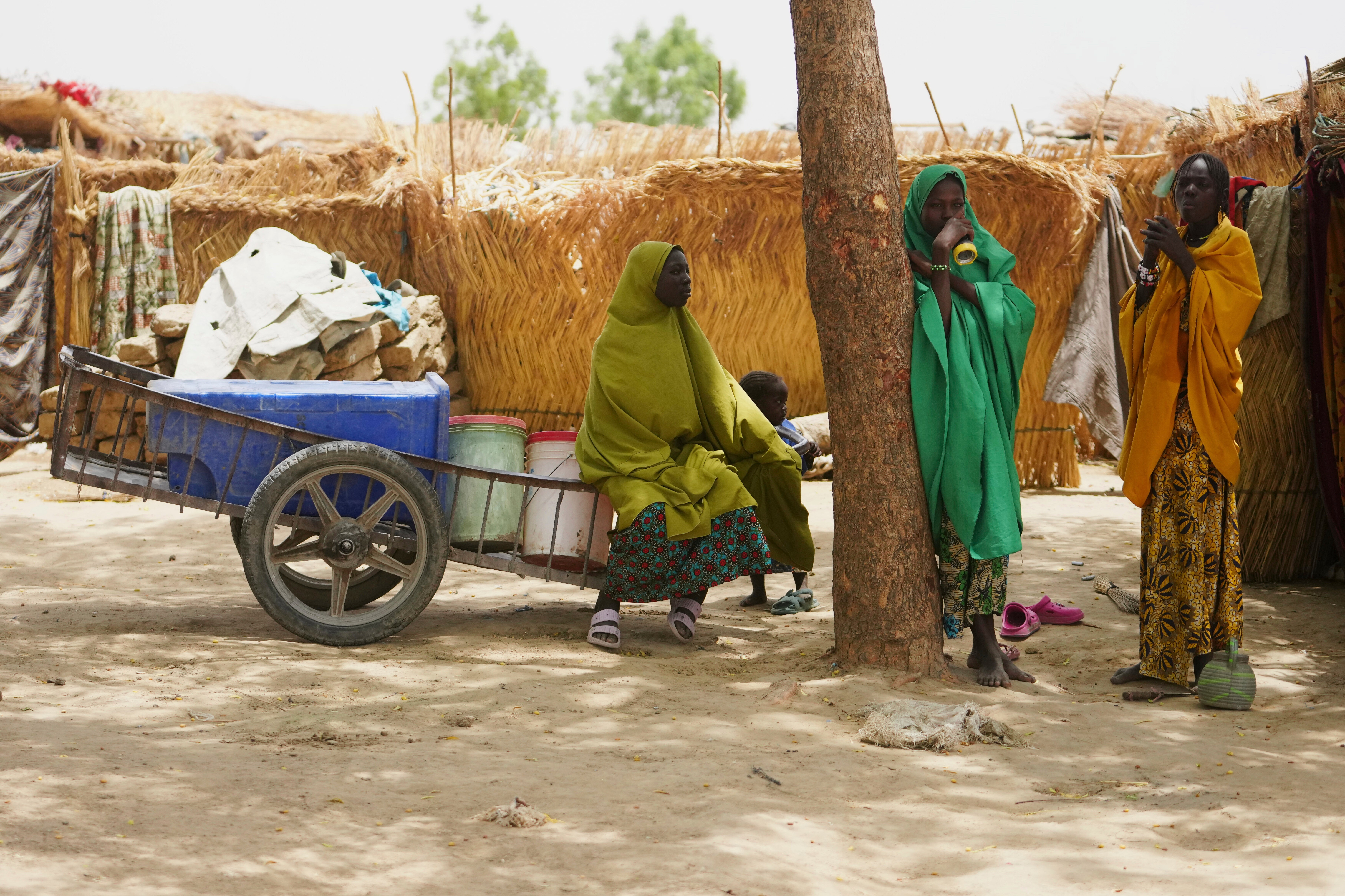 Women displaced by Boko haram attacks are seen outside there camp in Dikwa, north east Nigeria, April 29, 2025. (AP Photo/Sunday Alamba)