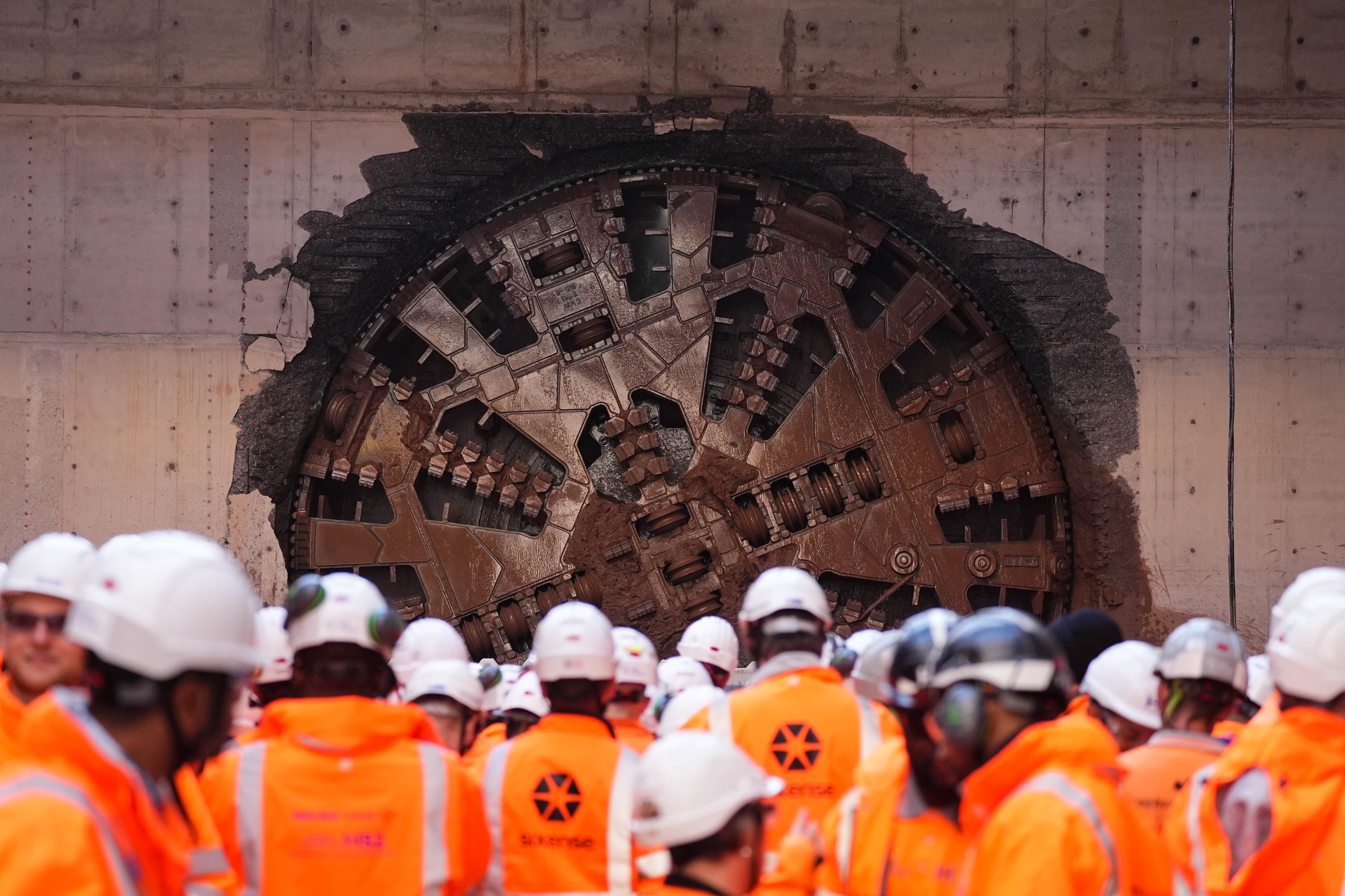 HS2 workers watch a boring machine breaking through (Jacob King/PA)