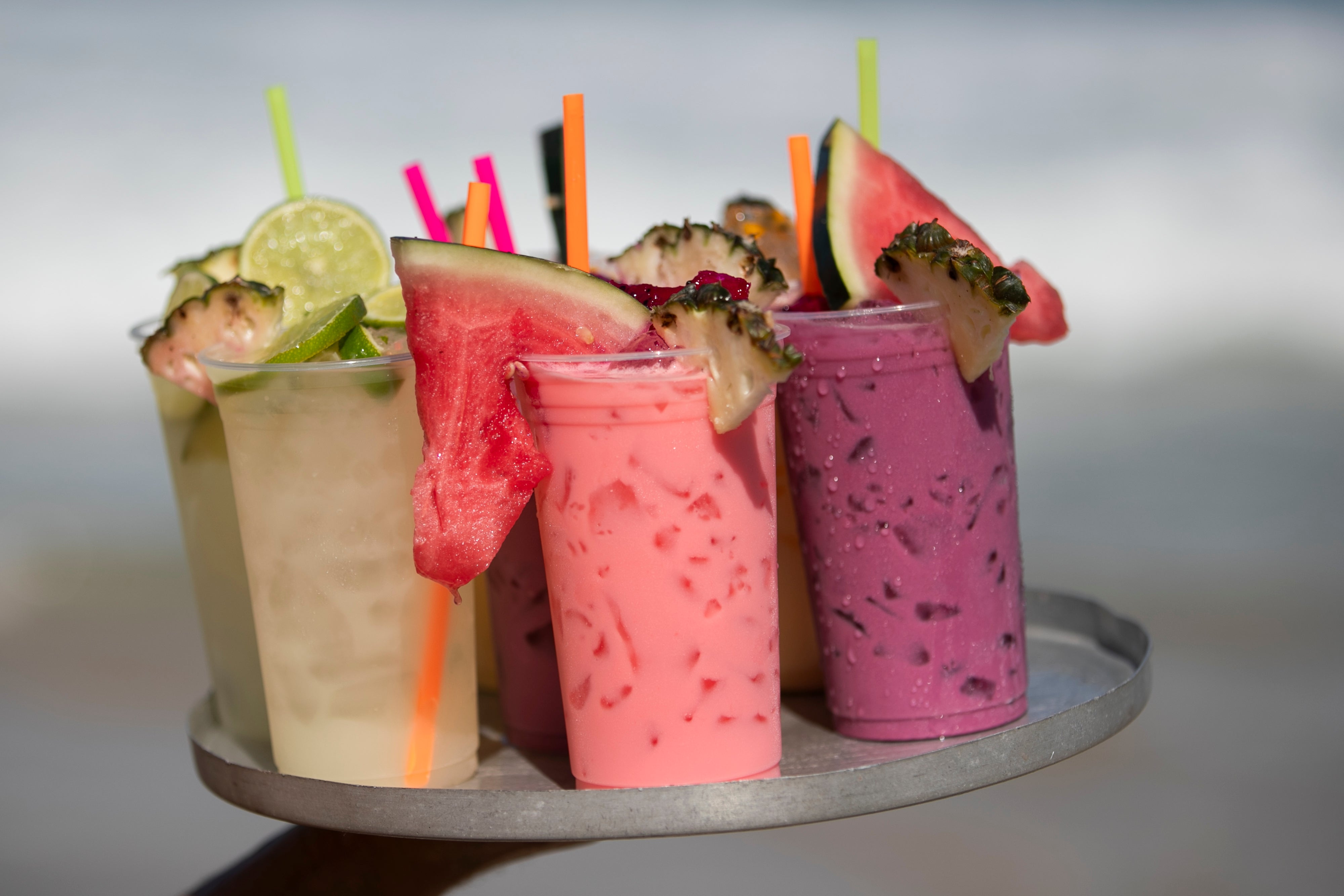 Vendor Leandro Azevedo carries a tray of fruit cocktail to customers on Ipanema Beach in Rio de Janeiro, Sunday, May 25, 2025. (AP Photo/Bruna Prado)