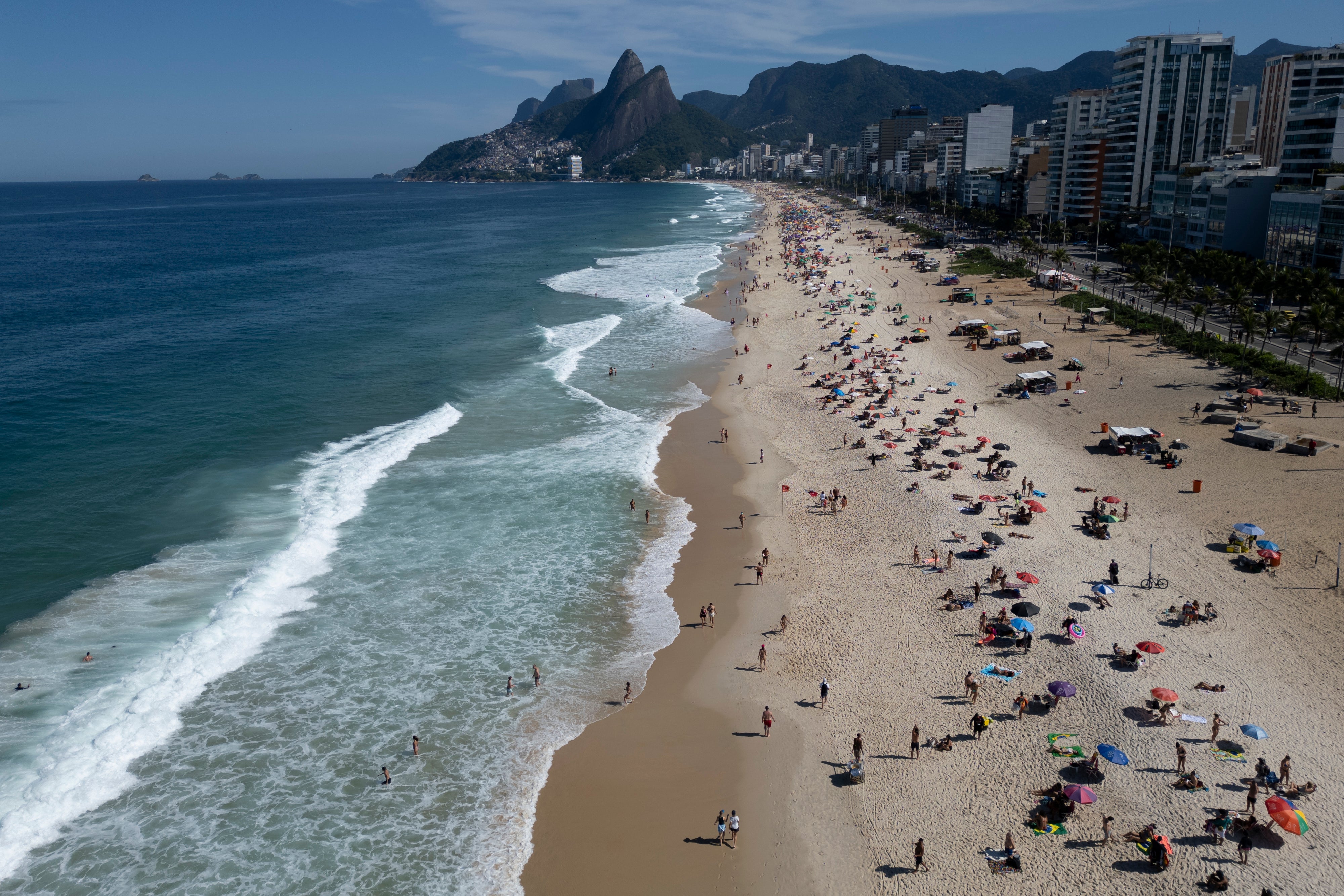 Beachgoers gather on the Ipanema Beach boardwalk in Rio de Janeiro, Sunday, May 25, 2025. (AP Photo/Bruna Prado)