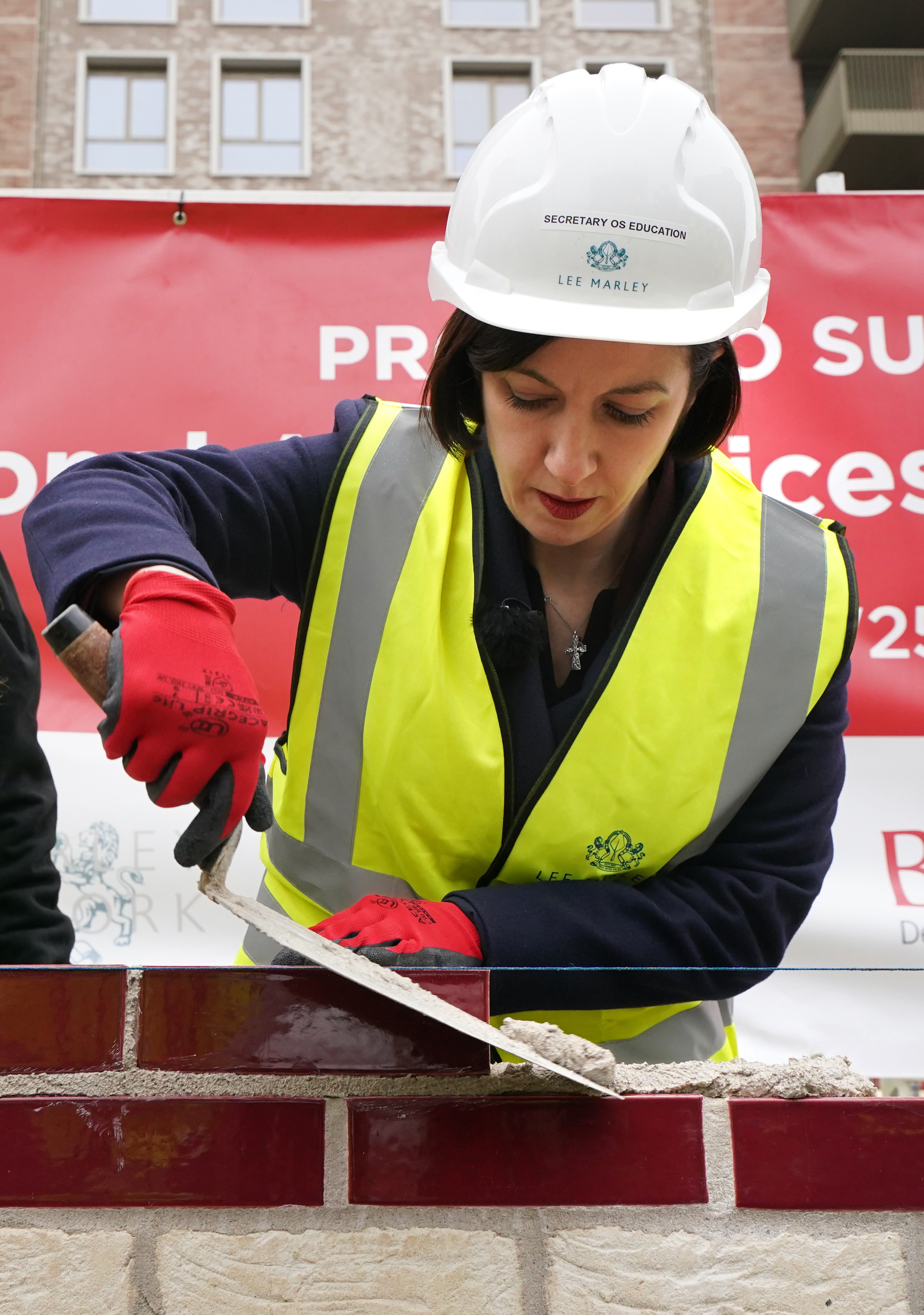 Education Secretary Bridget Phillipson having a go at bricklaying