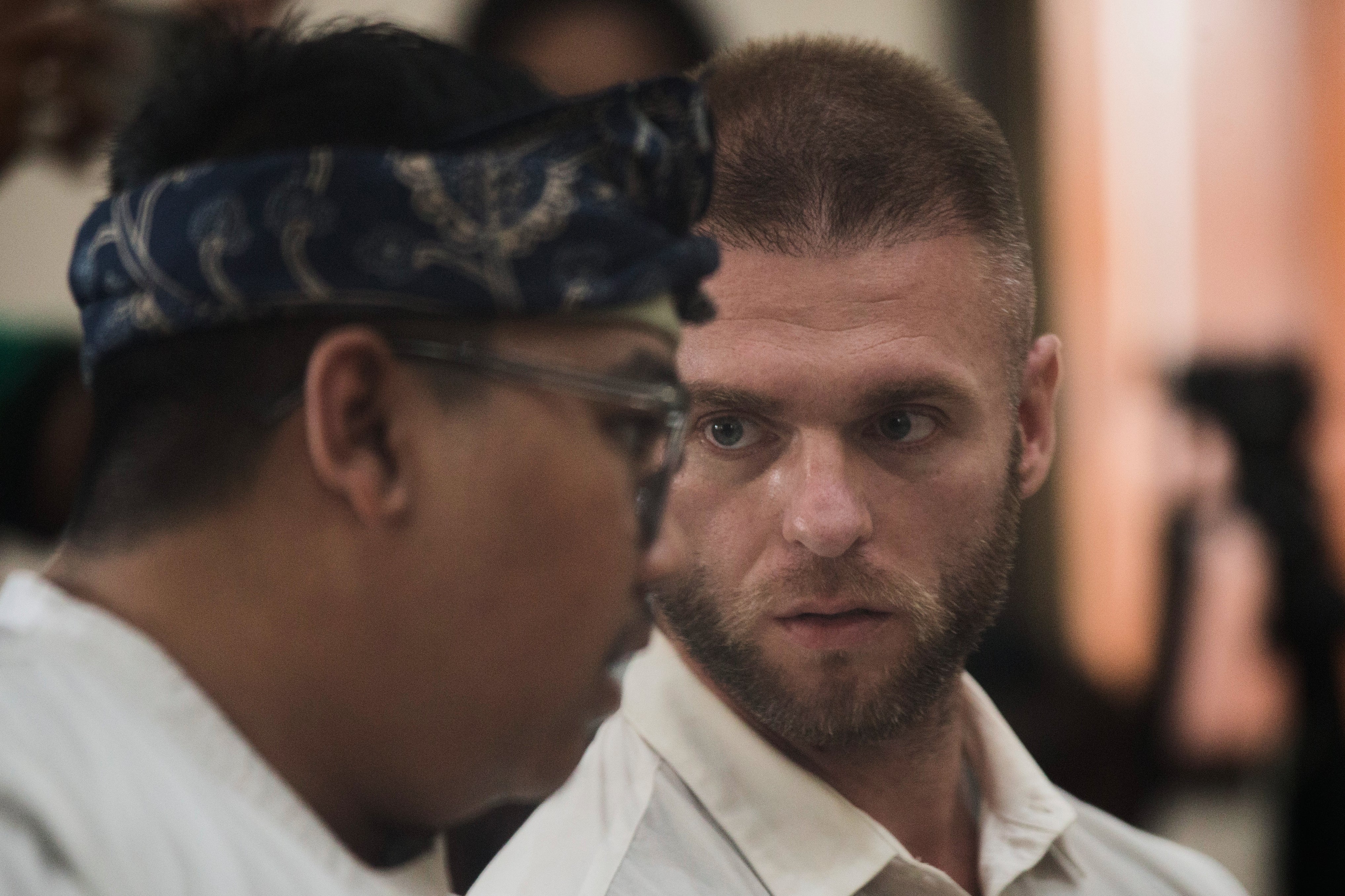 British citizen Thomas Parker sits on the defendant's chair before being sentenced for drug offences, in Denpasar in Bali, Indonesia