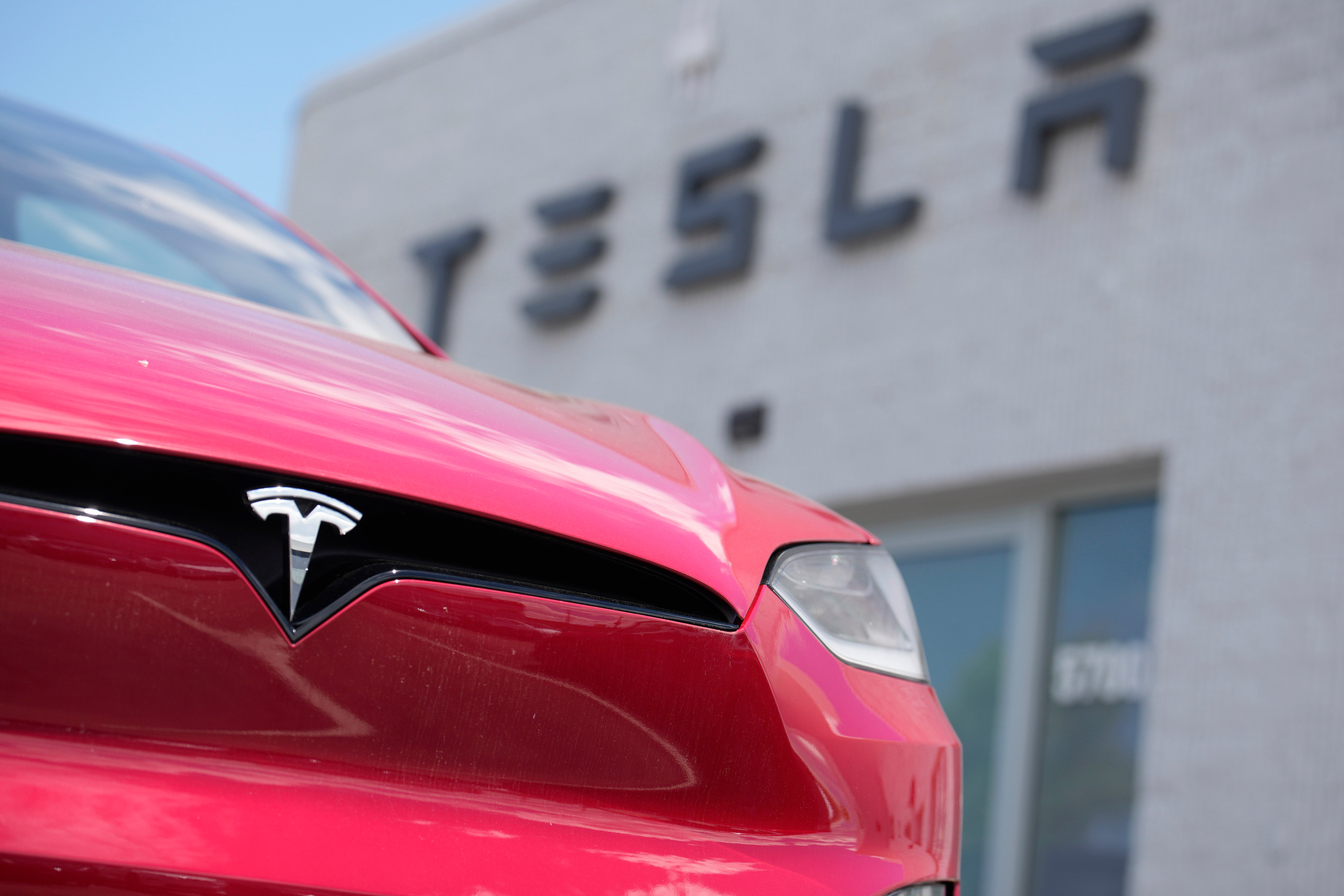 FILE - A Model X sports-utility vehicle sits outside a Tesla store in Littleton