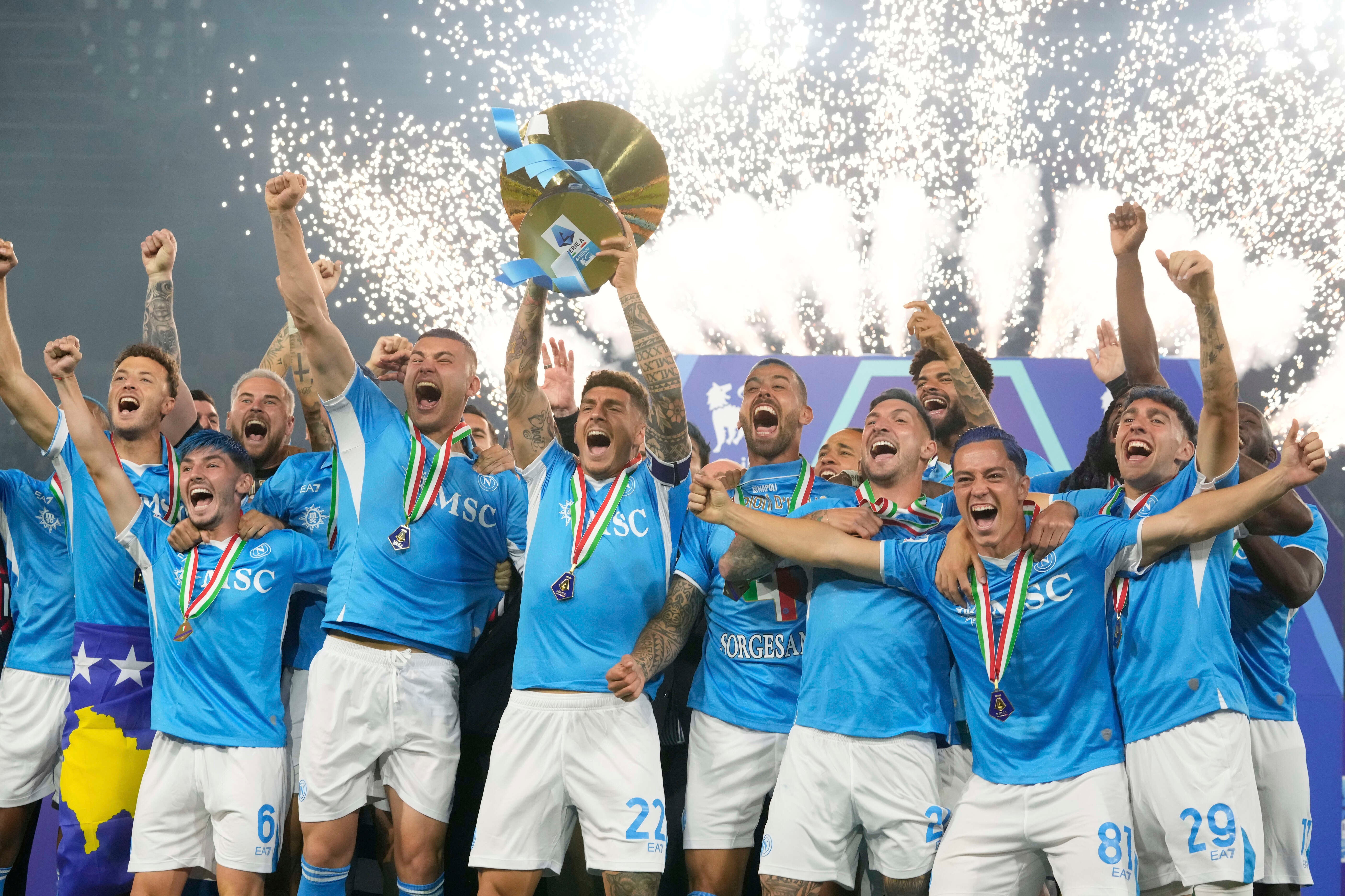 Napoli's team players celebrate during the awarding ceremony after winning the Italian league soccer title at the end of the Serie A soccer match between Napoli and Cagliari at the Diego Maradona stadium in Naples, Italy, Saturday, May 24, 2025