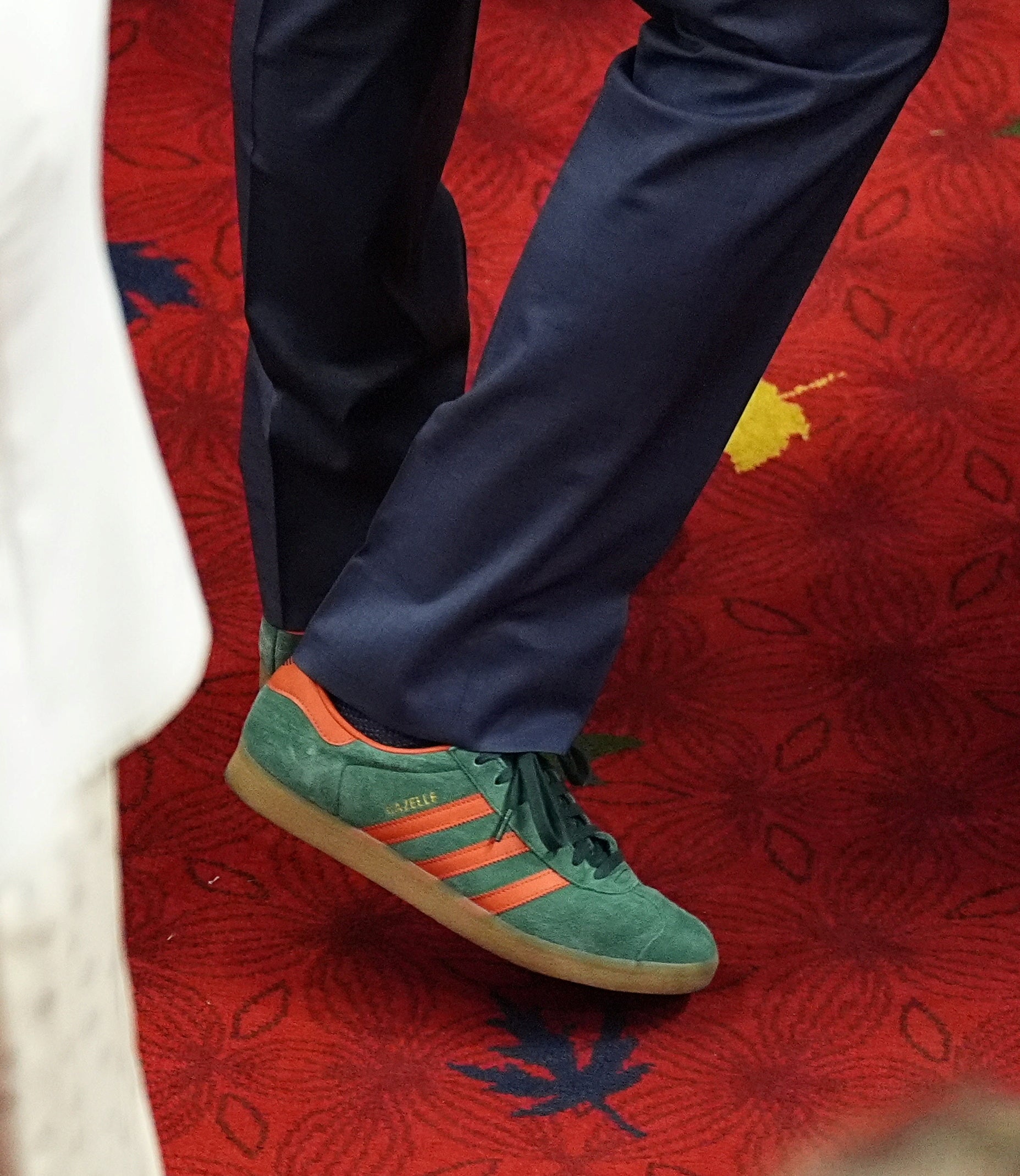 Trudeau paired his navy suit with a pair of green and orange Adidas Gazelles