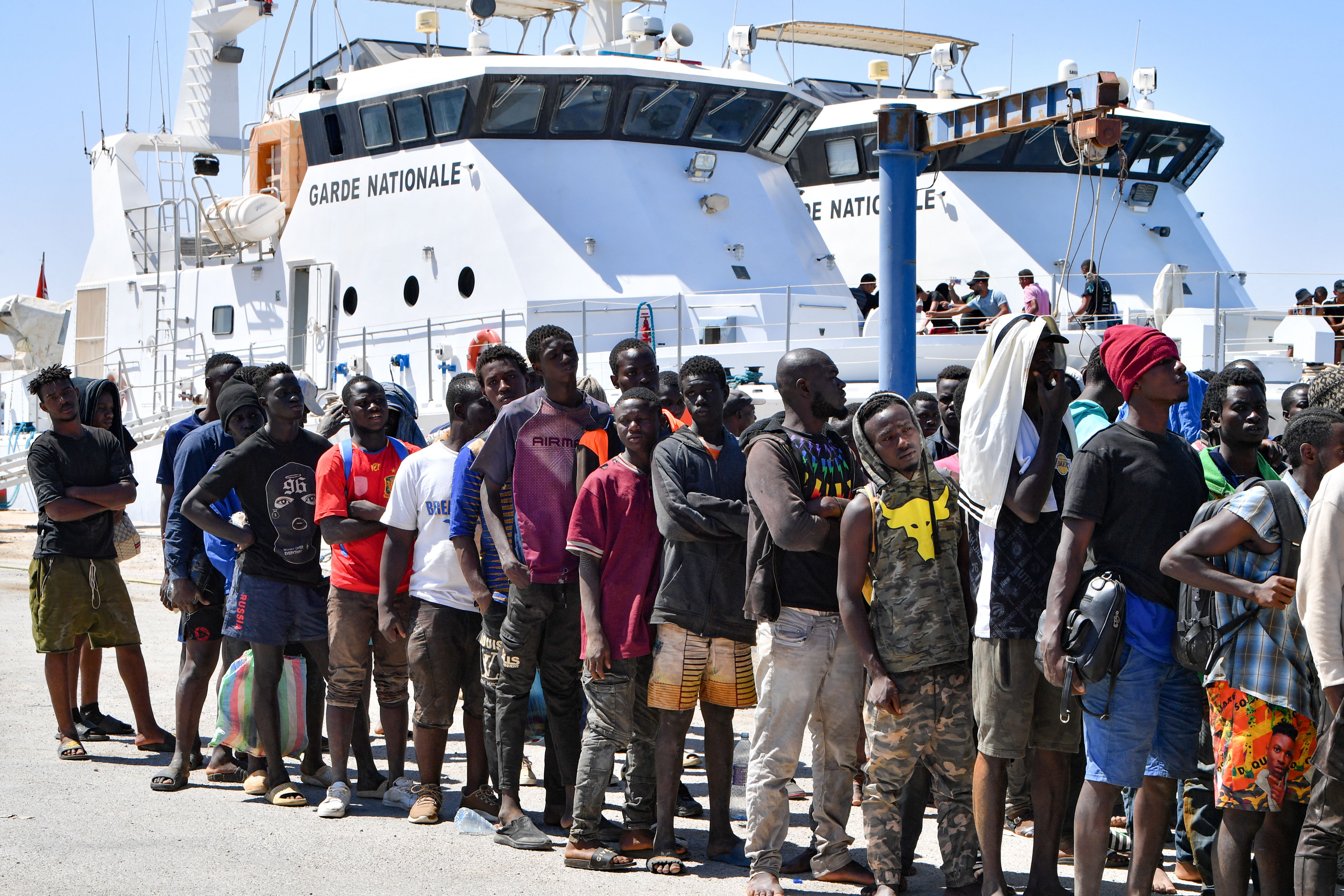 Migrants trying to flee to Europe after being intercepted at sea off the Tunisian coast