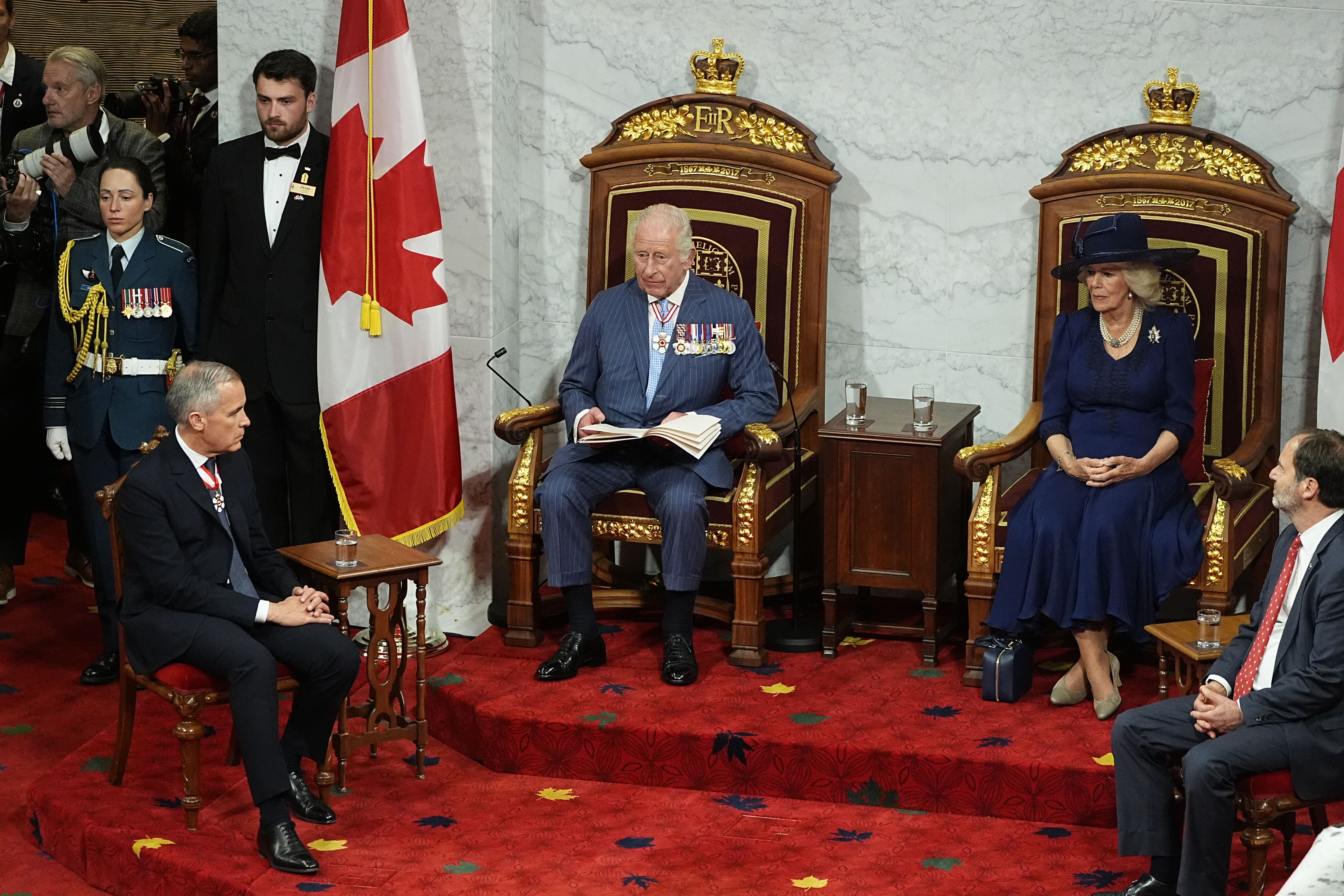 The Queen (second right) and Canadian Prime Minister Mark Carney (front left) listen to Charles (centre) during his speech (Aaron Chown/PA)