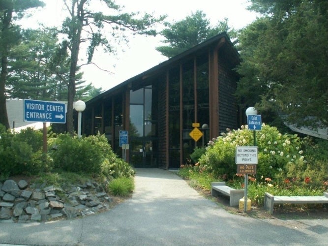 The Kittery Welcome Center off I-95 in Maine has some fun attractions like a camping-themed hang-out spot for kids, a life-sized Smokey Bear statue and a giant lobster trap to take photos with