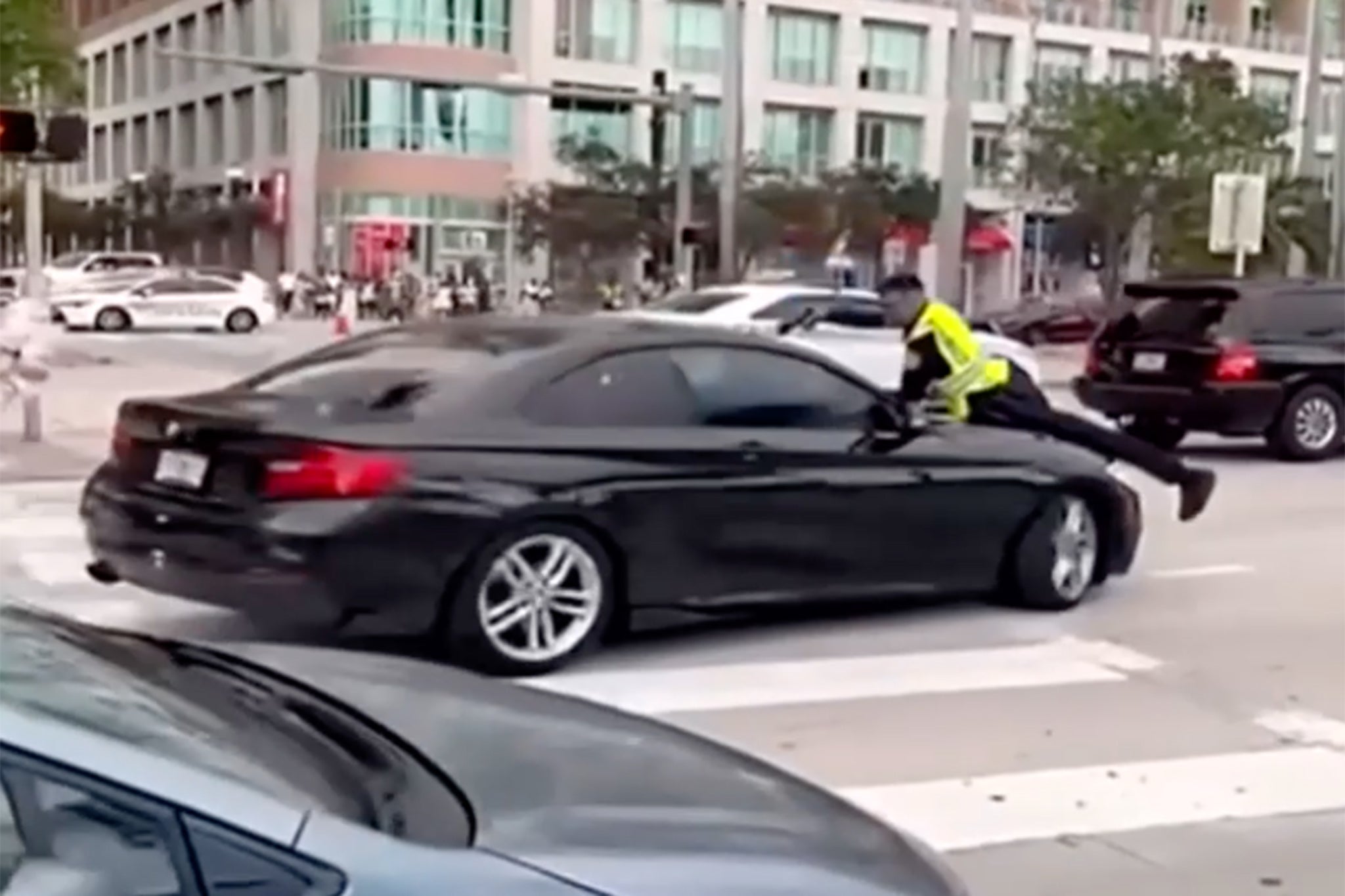 Cellphone video obtained Tuesday by Local 10 News shows the chaotic moments that led to a Miami police officer opening fire while on the hood of a car near Bayfront Park