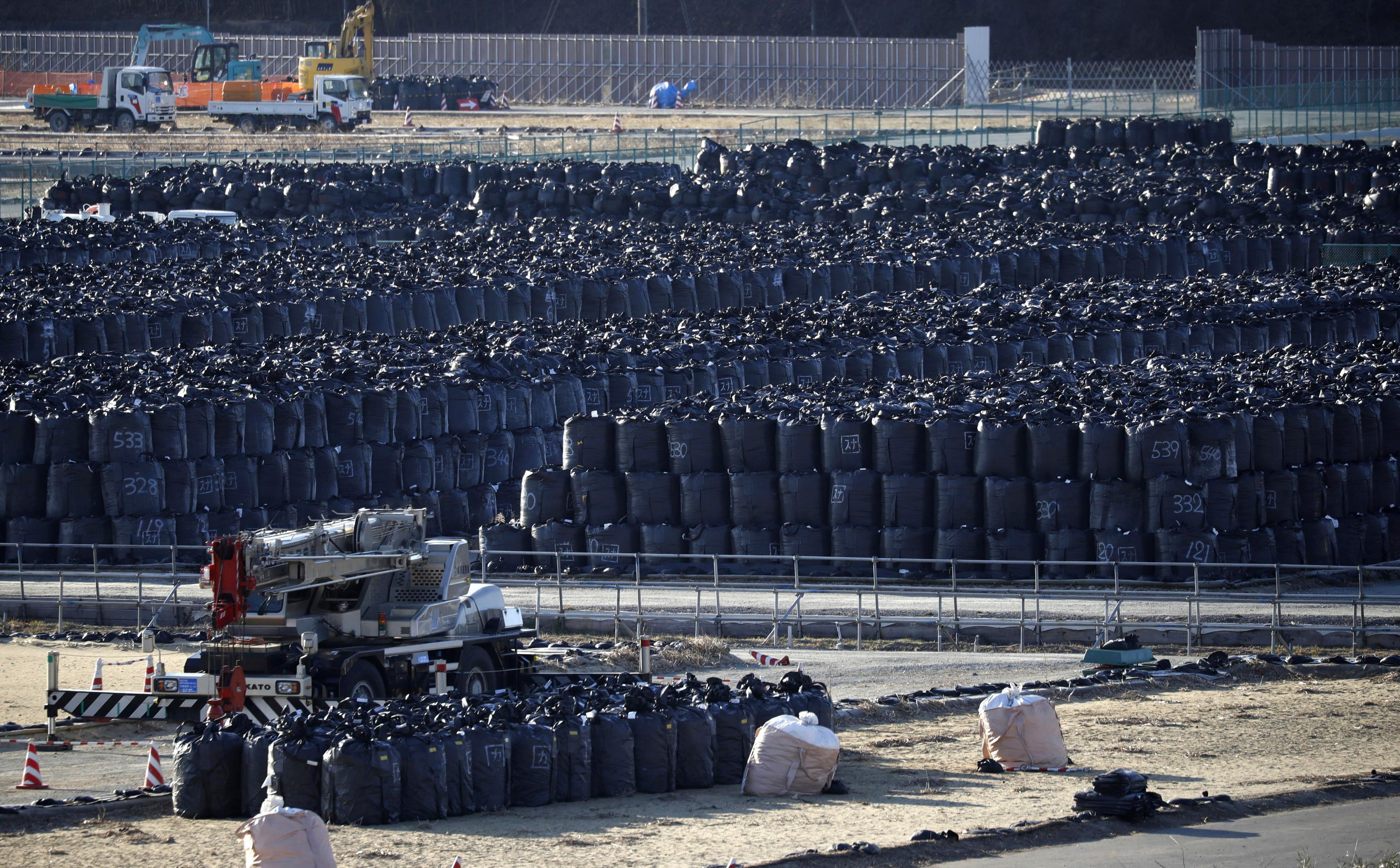 Black garbage bags filled with radioactive waste are kept temporally in a field in Minamisoma, Fukushima prefecture, Japan