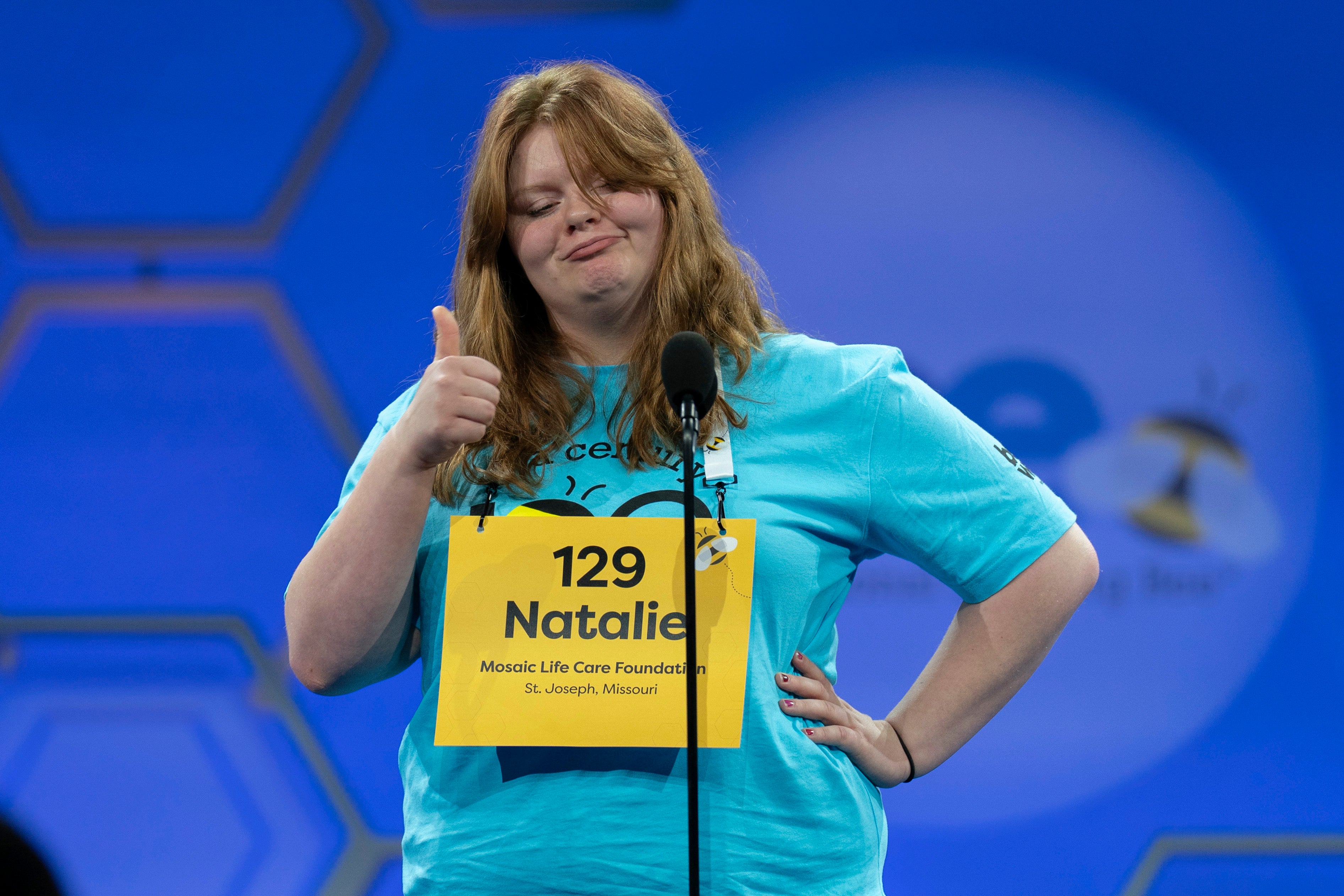 Natalie Mae Linthicum, 13, of St. Joseph, Mo., gestures as she spells her word during the first preliminary round of the Scripps National Spelling Bee