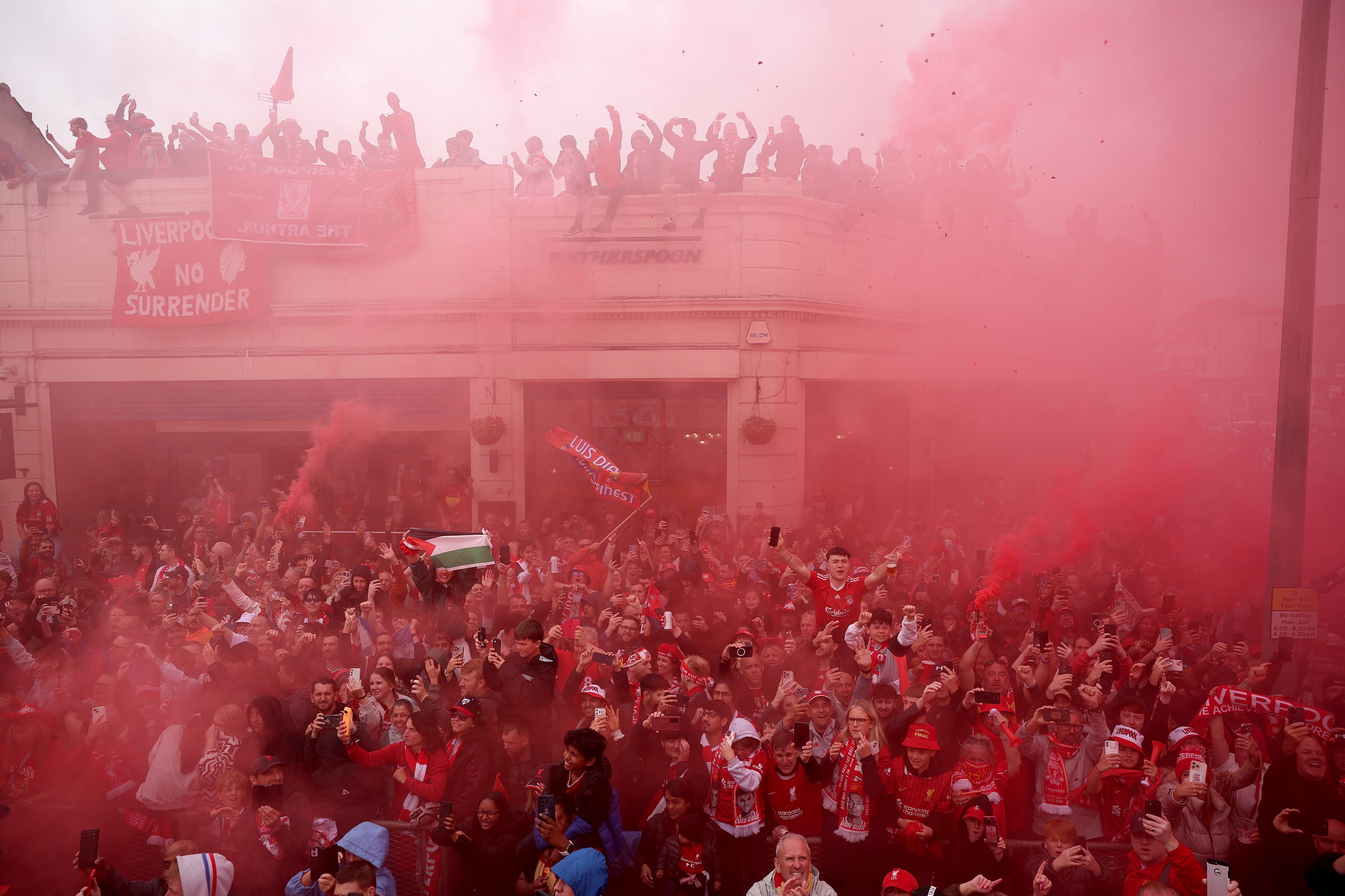 Liverpool fans line the streets during the team’s Premier League victory parade