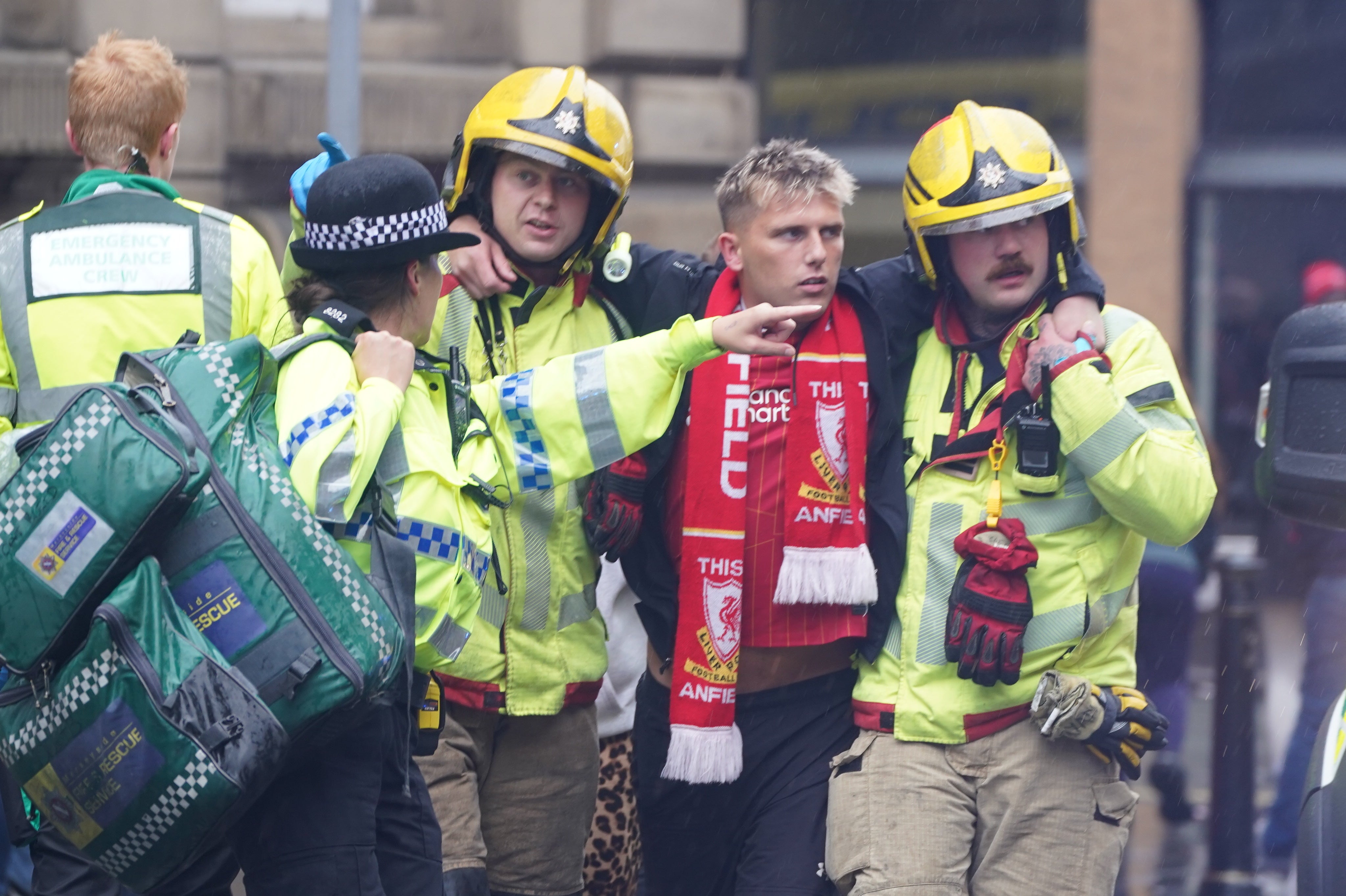 A Liverpool supporter is helped after the incident in Water Street (Owen Humphreys/PA)
