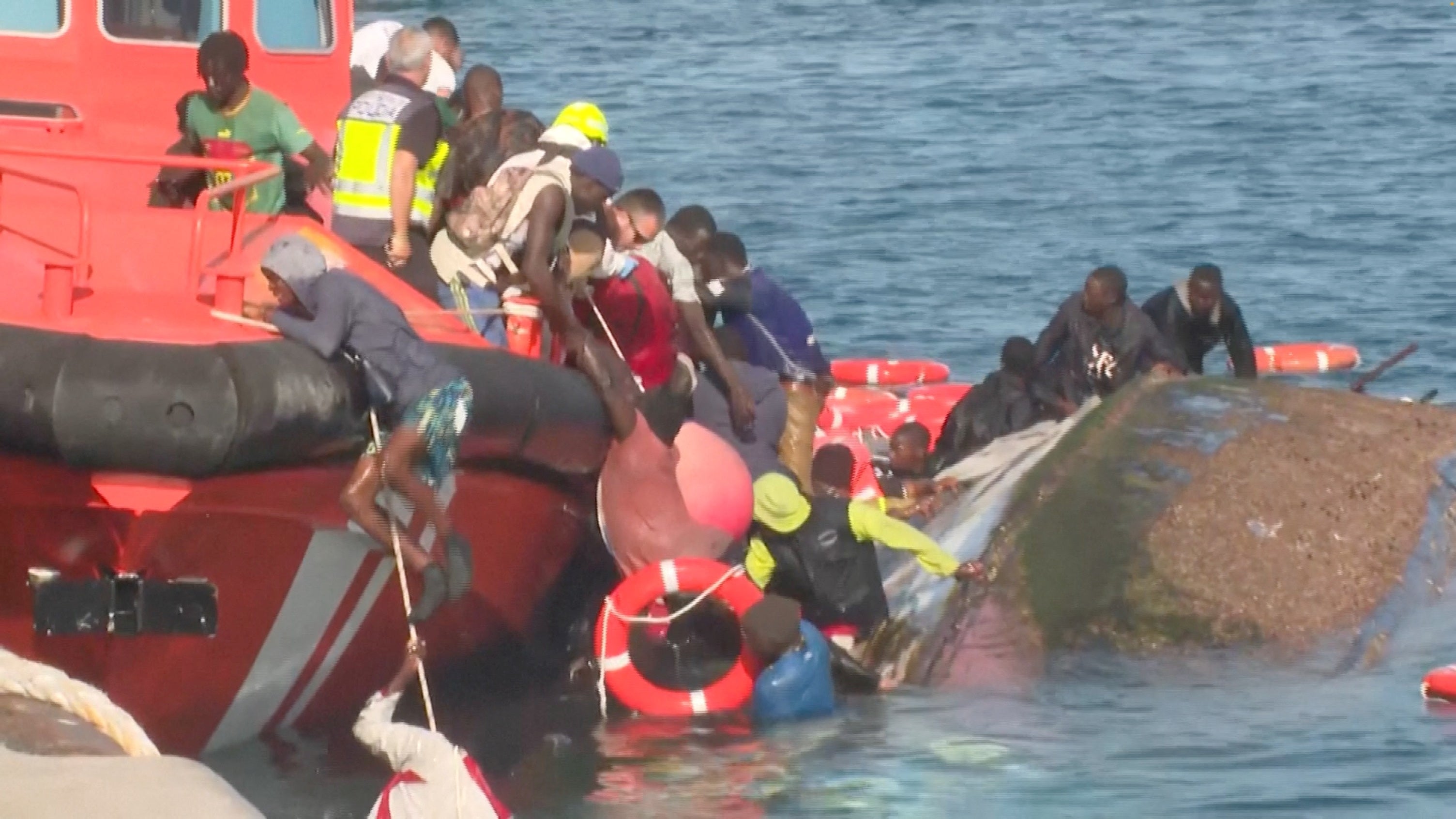 Emergency services trying to rescue migrants from the water, as a migrant boat capsized, in La Restinga