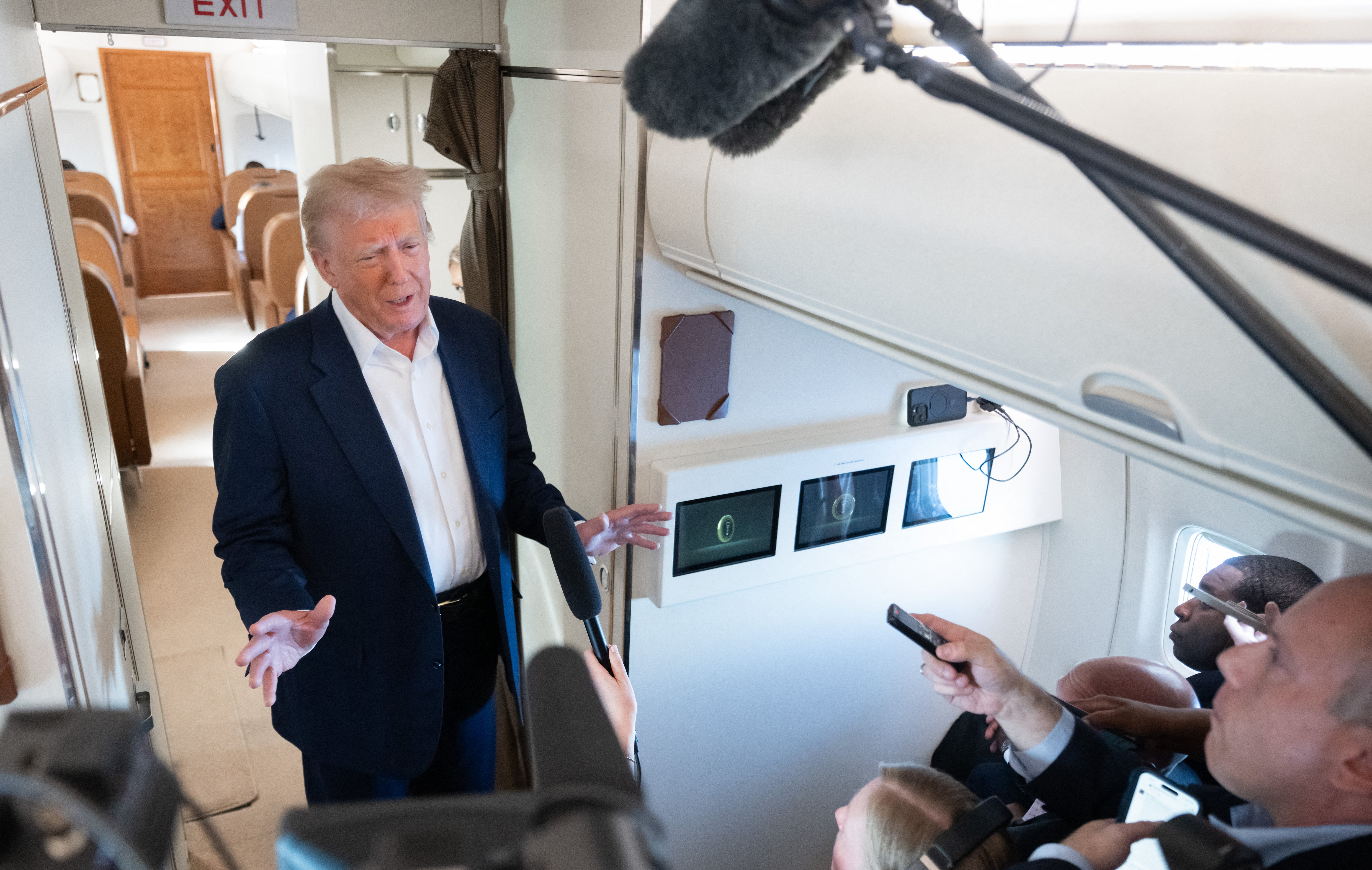 US President Donald Trump speaks with the media aboard Air Force One as he flies from West Palm Beach, Florida enroute to Joint Base Andrews in Maryland, on May 4, 2025 returning to the White House after spending the weekend in Florida