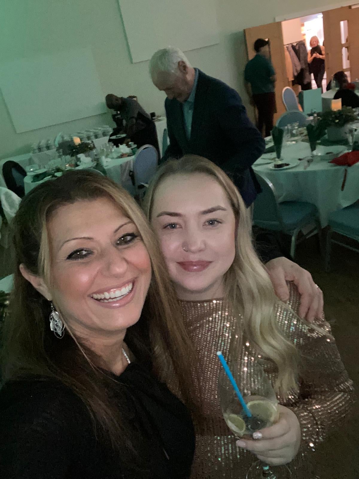 Lily and the dermatology surgeon at the work Christmas party