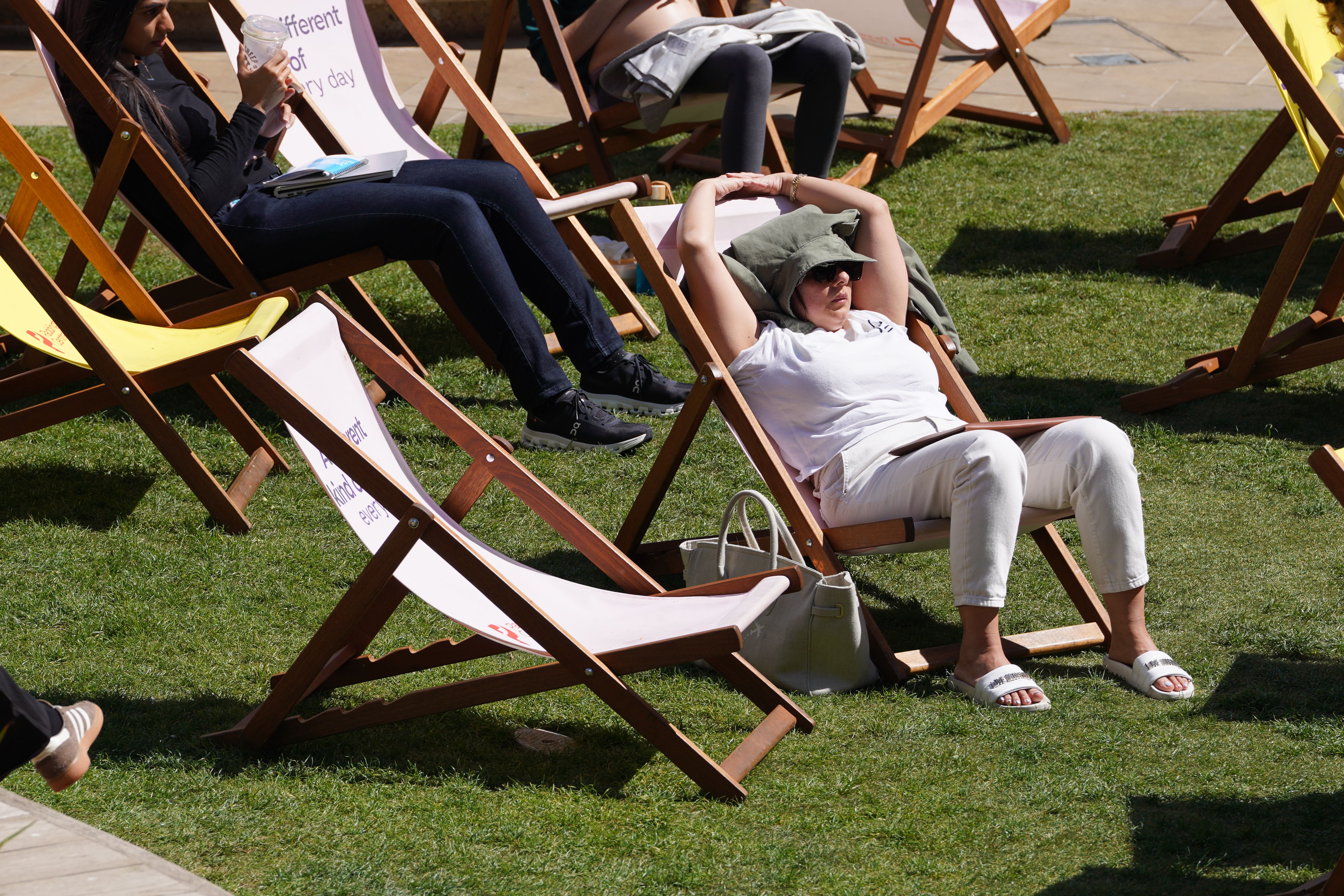 People enjoying the spring sunshine in Paddington, London (Lucy North/PA)