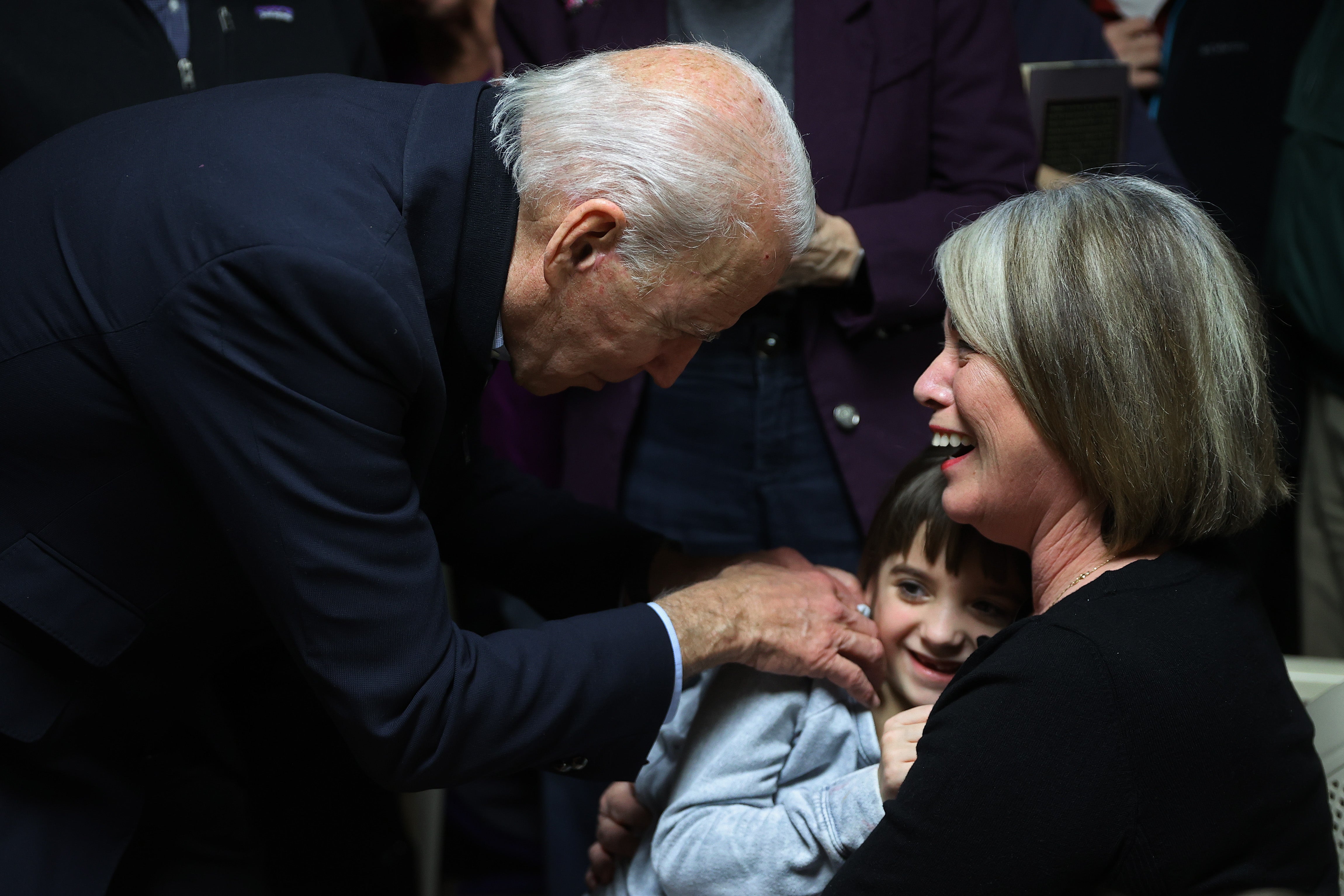 Former former US president Joe Biden tickles a child during a campaign