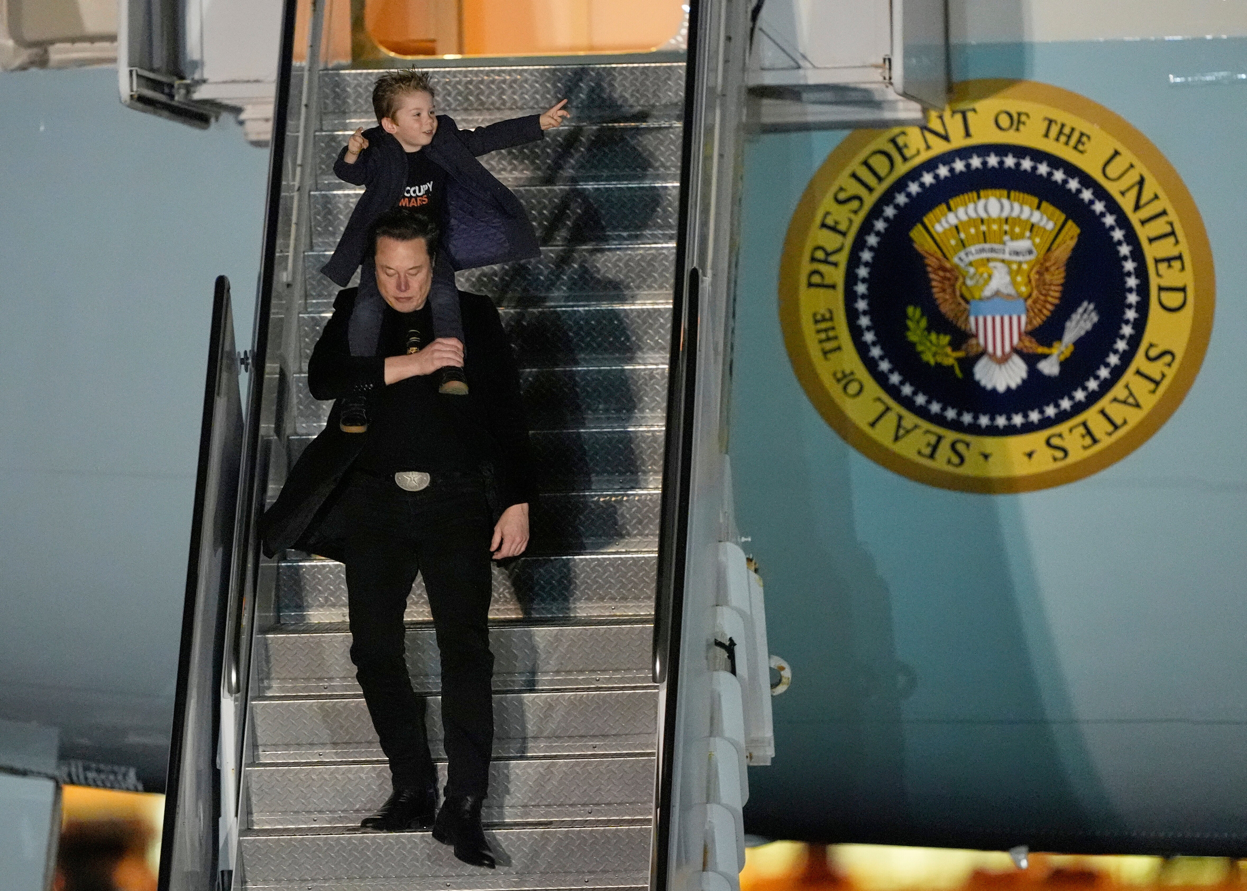 Elon Musk carries his son X Æ A-Xii as they arrives on Air Force One with President Donald Trump, not pictured, at Miami International Airport, April 12, 2025, in Miami, Fla. (AP Photo/Manuel Balce Ceneta, File)