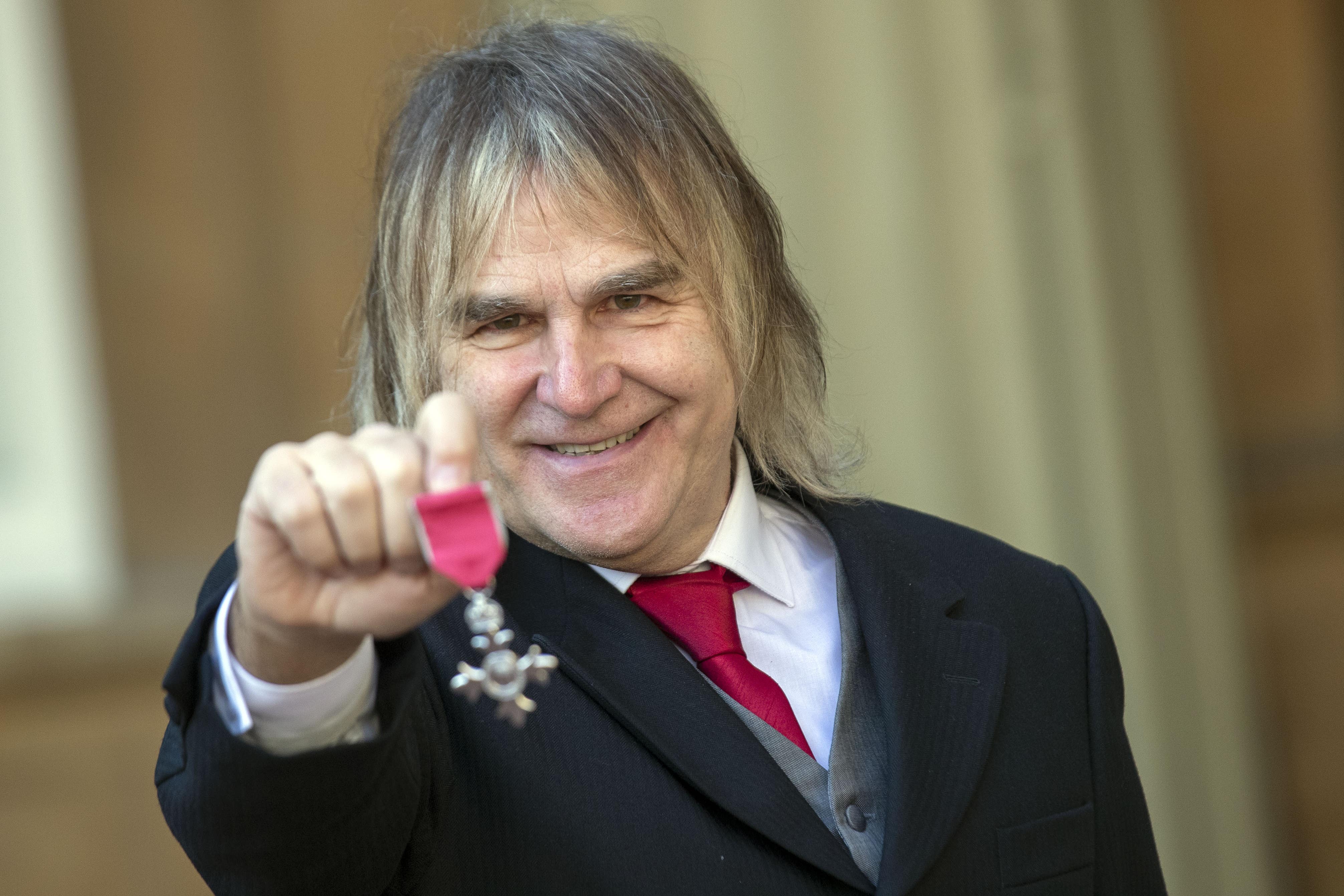 Mike Peters was awarded an MBE for voluntary services to cancer care (Steve Parsons/PA)