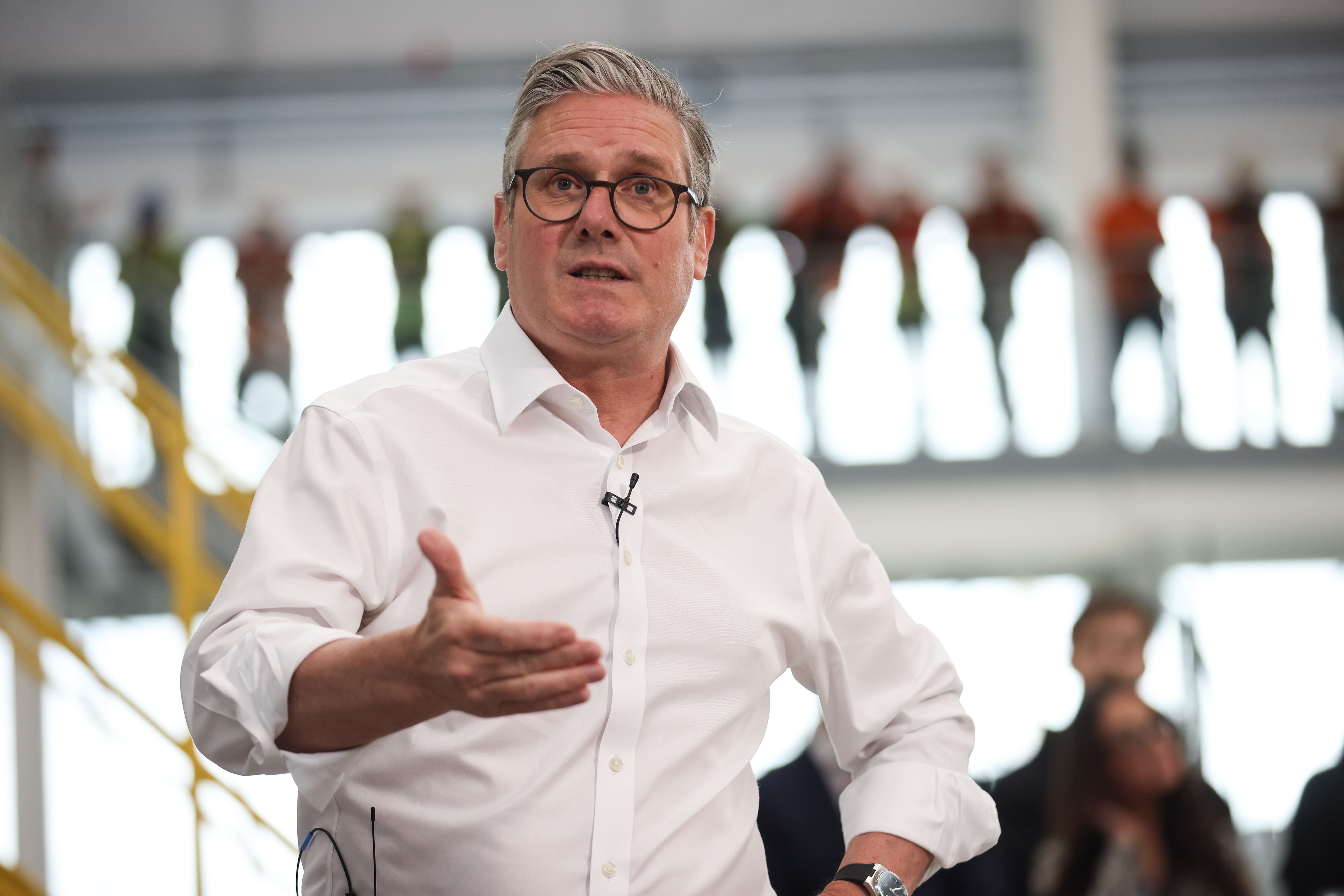 Prime Minister Sir Keir Starmer speaks to workers during a visit to Glass Futures in St Helens (PA)
