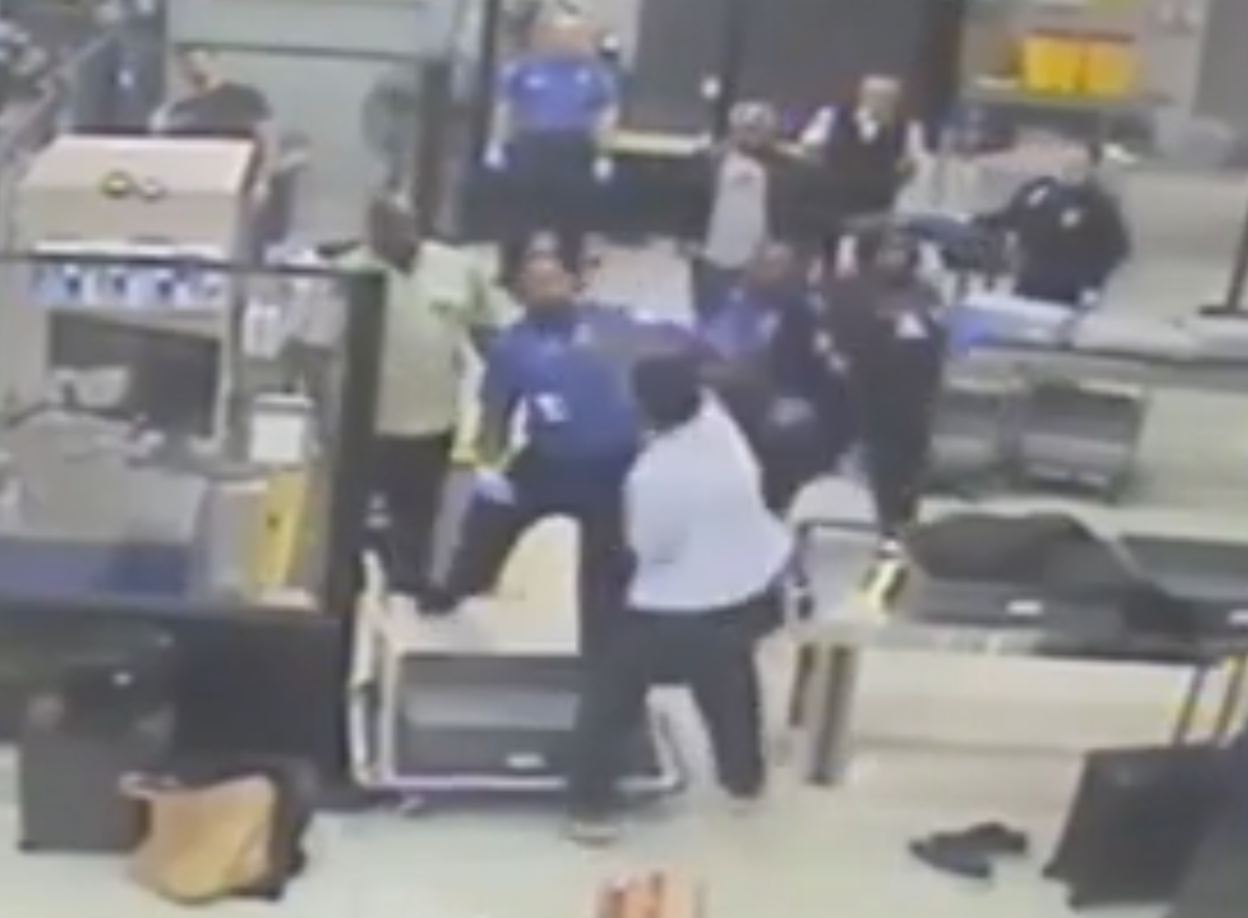 Cameron McDougall, of Toronto, Ontario, is seen in security footage throwing a punch at a TSA agent near a security screening station in Miami International Airport on December 28, 2024. McDougall has pleaded guilty to two charges and faces up to two years in prison. Video of the attack was recently released.