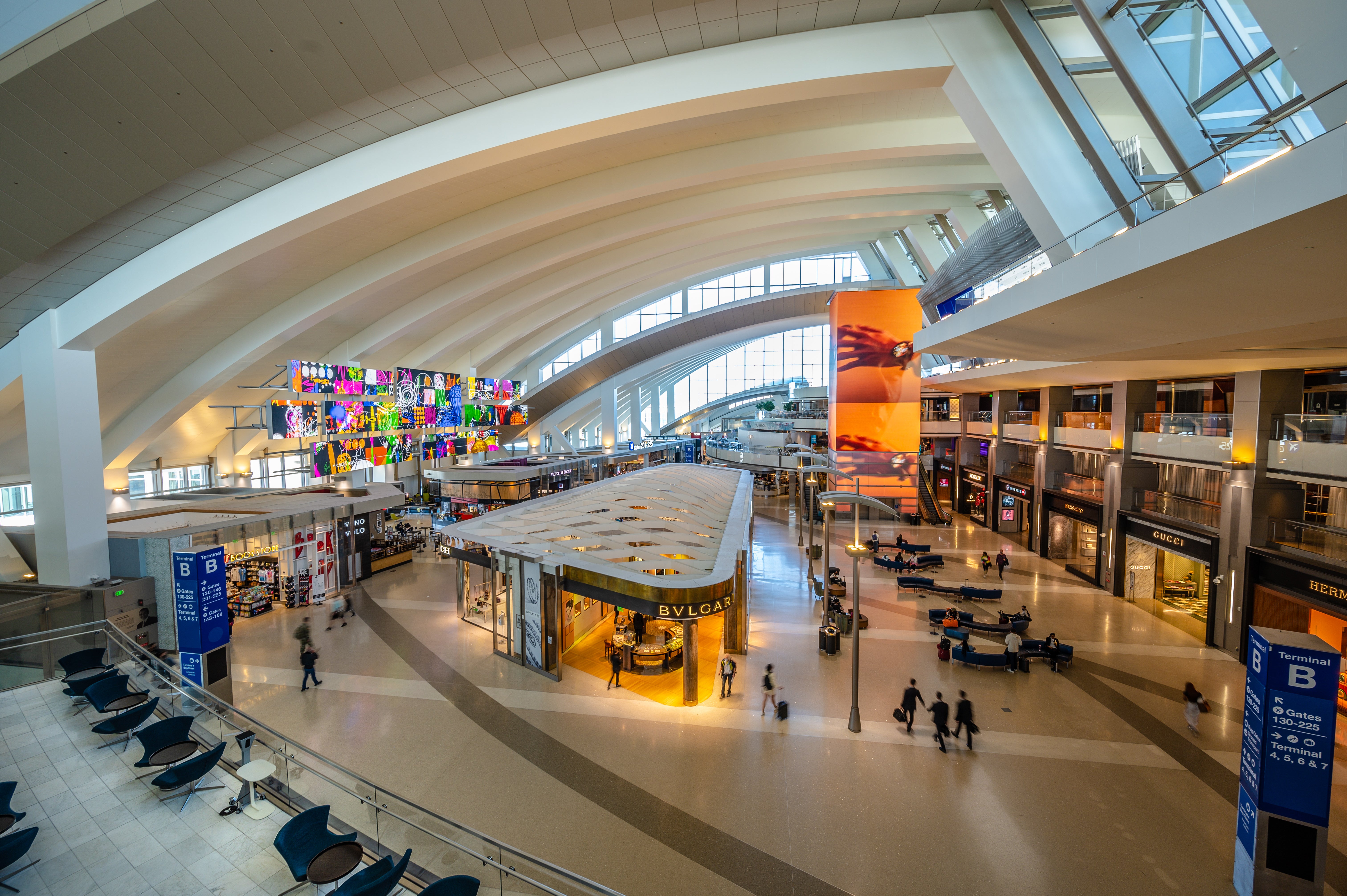 LAX has nine terminals shaped like a horseshoe, 'with constant detours and endless people'. Above is the Tom Bradley Terminal main hall